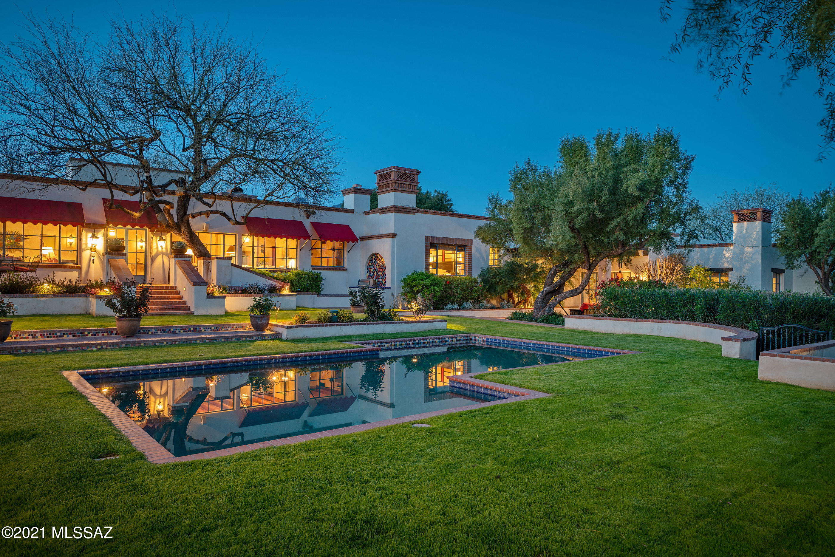 A home has long been thought of as a place of refuge, exemplified by this private and secluded hilltop estate situated on over 2 acres in the heart of the Catalina Foothills. This quintessential Tucson estate home is uniquely sited to offer unfettered and dramatic view portals that stretch out over the lush mature gardens, echoing the rhythm of its natural surroundings. An architecturally significant property, privately gated and originally designed by celebrated architect Josias Joesler at the height of his career. In 2007 the current owners embarked on an ambitious and sensitive remodel enlisting the assistance of local architect Ron Robinette, with the help of Gordon McKinley, and Galen Hasenpflug to preserve and protect the vision articulating this romantic regional vernacular home. The extensive remodel meticulously restored original details, while infusing the latest modern advancements and curated materials sourced from around the world. Envisioned for both large-scale entertaining and intimate family life this 8,107 square foot fully sustainable home offers Solyndra rooftop solar panels, larger underground cisterns harvesting rainwater for landscape irrigation and a private water well, all of which harness the natural resources, while optimizing cost efficient energy and water usage. 

Enter into a living environment with a sense of permanence and architecture that is a reflection of the rich and lush landscape that extends the architectural palette, evoking a feeling of lifestyle that responds to the unified dialog between the architecture and the adjoining landscape. Maximizing the home's dramatic relationship between interior and exterior spaces is achieved through careful design and placement of the structure, with connectivity to various courtyards.

Beyond the home's private entry, one is greeted by a light-filled and cozy floor plan, replete with warm vertical tones and textures complimented by the exquisite custom millwork, providing a visual and tactile experience. The main Zaguan opens onto the sophisticated formal living room featuring the original refinished 1940's beamed ceilings, with stunning Mesquite and Turkish travertine flooring that floats seamlessly into the kitchen and family rooms, providing a subtle yet delicate contrast.

The heart of the home is the fabulous Chef's kitchen with impeccable fit and finish throughout, including custom cabinetry, granite countertops, top-end stainless steel appliances, surrounding the exquisite custom-tailored Island offering an array of service counter space, acting as a focal point in this kitchen designed to substantial scale and comfort.

Accommodations are split across the primary level, with four ensuite bedrooms to be found in the main residence, including the owners suite concealed on the East wing of the property, boasting a sumptuously appointed bathroom, with large walk-in shower and radiant heated rooms, as well as separate lounge and office areas, with doors opening out onto a private veranda. The detached guest casita is elevated and situated on the Southwest end of the property, featuring a living room, kitchenette and separate bedroom/bath, with a spiral staircase leading to the rooftop deck providing unobstructed views. 

Light and shade, openness and enclosure, make for an inviting ambiance, with a succession of courtyards resulting in a juxtaposition of private and social spaces. Quiet sitting areas sequestered throughout the property, with covered dining patios unwinding like a narrative of texture, light and mood, emphasizing entertainment as a key element of the outdoor lifestyle.