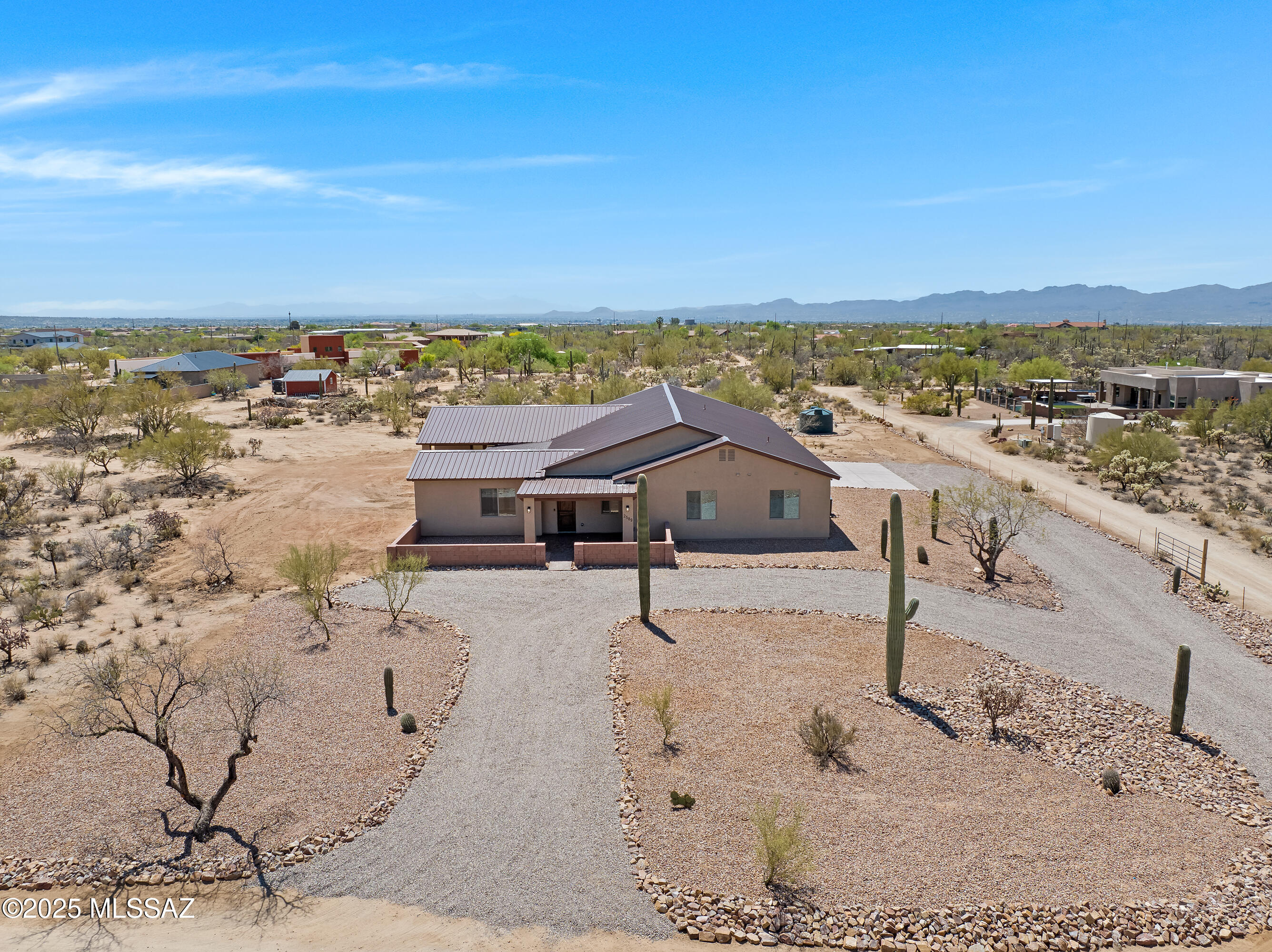 Newly Built!  Enjoy Tortolita and Catalina Mountain views on over 3.5 acres with no HOA!   Warm and inviting, the timeless design will instantly make you feel at home. Amenities include a private home office, spacious great room, a beautiful and functional kitchen with Frigidaire Gallery appliances, an induction cooktop, and a separate beverage refrigerator perfect for entertaining. The primary suite is truly a retreat, featuring a gorgeous bath and generous closet.  Along with the primary bedroom, 2 guest bedrooms host ensuite baths. Amply-sized bedrooms 4 and 5 adjoin walk-in closets.  Tech features include security cameras outside and a multi-zoned sound system with speakers throughout the home, back porch, and garage.  The garage also has a 240-volt outlet.