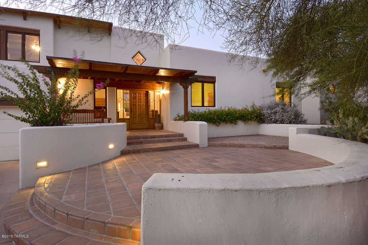 ''Expect the Unexpected'' This home could of only been built by a native Tucsonian. 
Masonry, huge patios facing the Catalinas, outdoor living that was designed for everyone, and the best...solar!Soaring ceilings, numerous doors to patios, and still pay so little for electricity! Of course AC,& evap as well.5th bedroom is beautiful office currently.Sitting in the heart of the foothills, in a secret little neighborhood, and yet minutes away from everything.  I can't begin to describe the equally amazing inside.  Tile floors, thick walls, niches, and a prevailing feeling of one space leading to another. The majority of the home is on the main level but don't miss the huge ''extra'' living upstairs, of course with a private upstairs patio for city views!I love this one...can you tell?!