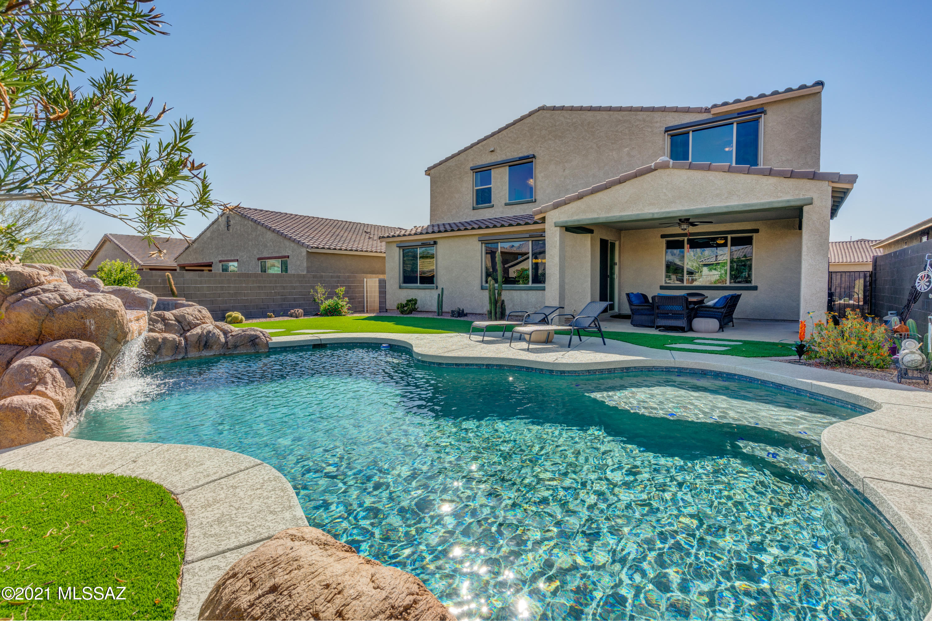 Gated 5 bed/4 bath Family Home has it all! Popular Meritage Floor Plan - Sonoita.  Huge Owners Suite with Catalina Mountain Views. Resort style yard w/ Heated Pool, Rock Water Fall Grotto, Hot Tub and more. Cook's Kitchen with Matte Monte Cristo Granite Counters and Island. Multiple Living Spaces Throughout. Close to all your Oro Valley favorites!  Walking distance to Wilson K-8 & Ironwood High.  Don't miss this one!