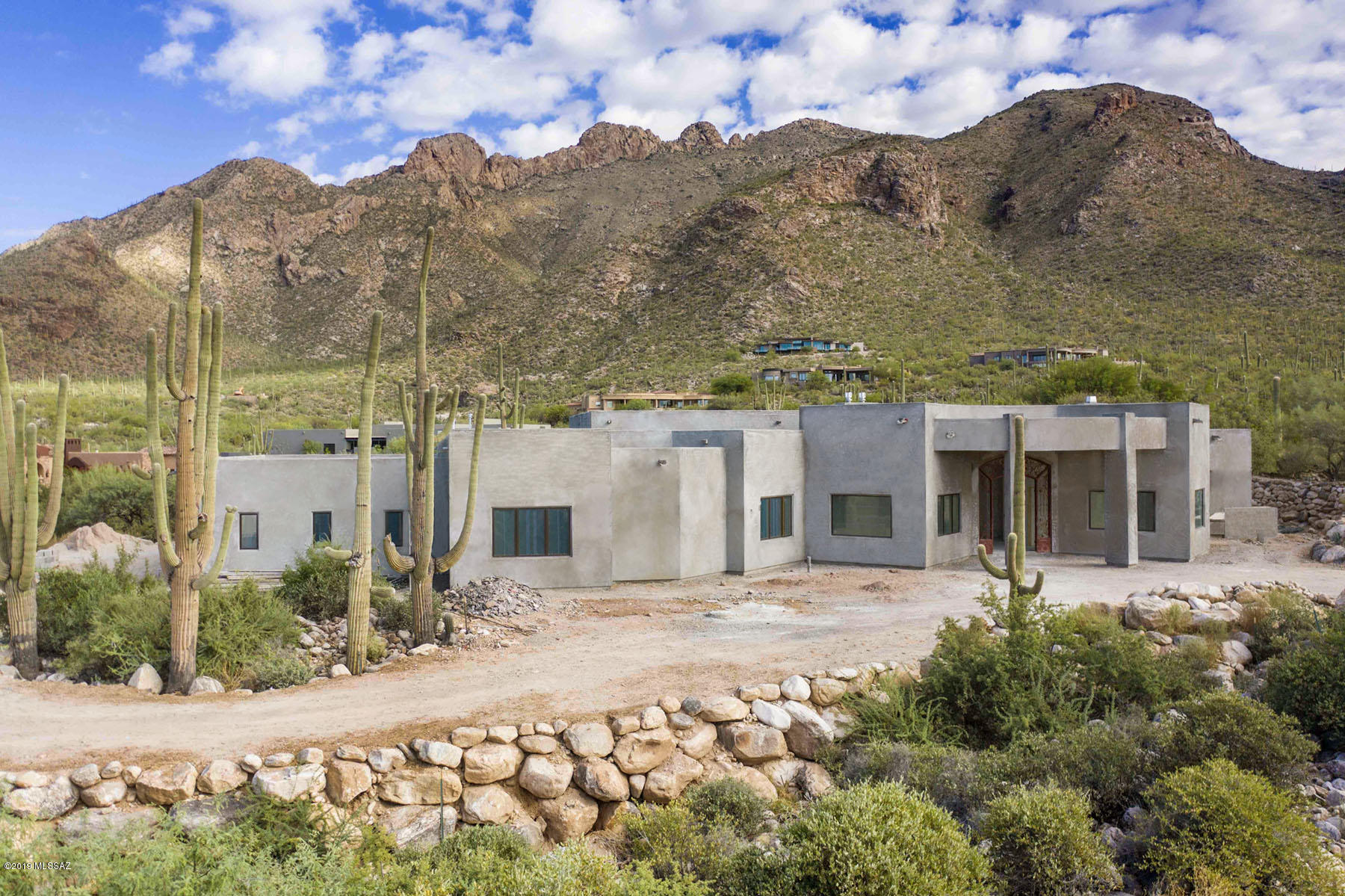 Stunning brand new contemporary w/6099 sq.ft to be completed February 2020. Breathtaking mountain views in prestigious gated Pima Canyon. Exquisite foyer entry w/wrought iron front doors, dramatic 16 ft. ceilings, elegant living rm w/fireplace, walls of windows, formal dining rm, gourmet island kitchen w/quartz countertops, stainless appliances, gas top range, double ovens, 2 dishwashers, 48 '' refrigerator/freezer, breakfast area opens  to family rm w/fireplace, gorgeous marble flrs,Pella windows, 8 ft &10 ft. doors,4 BR's + study or 5 BR's & 4.5 BA's. Master w/fireplace, lux bath w/quartz countertops, 
marble flrs, Jacuzzi tub, rain shower,large walk in closet & priv. entry to patio. Gracious bkyd w/ cov'd patio,pool,spa,grass,4 car garage & mtn views. Flr pln under photos/virtual tour.