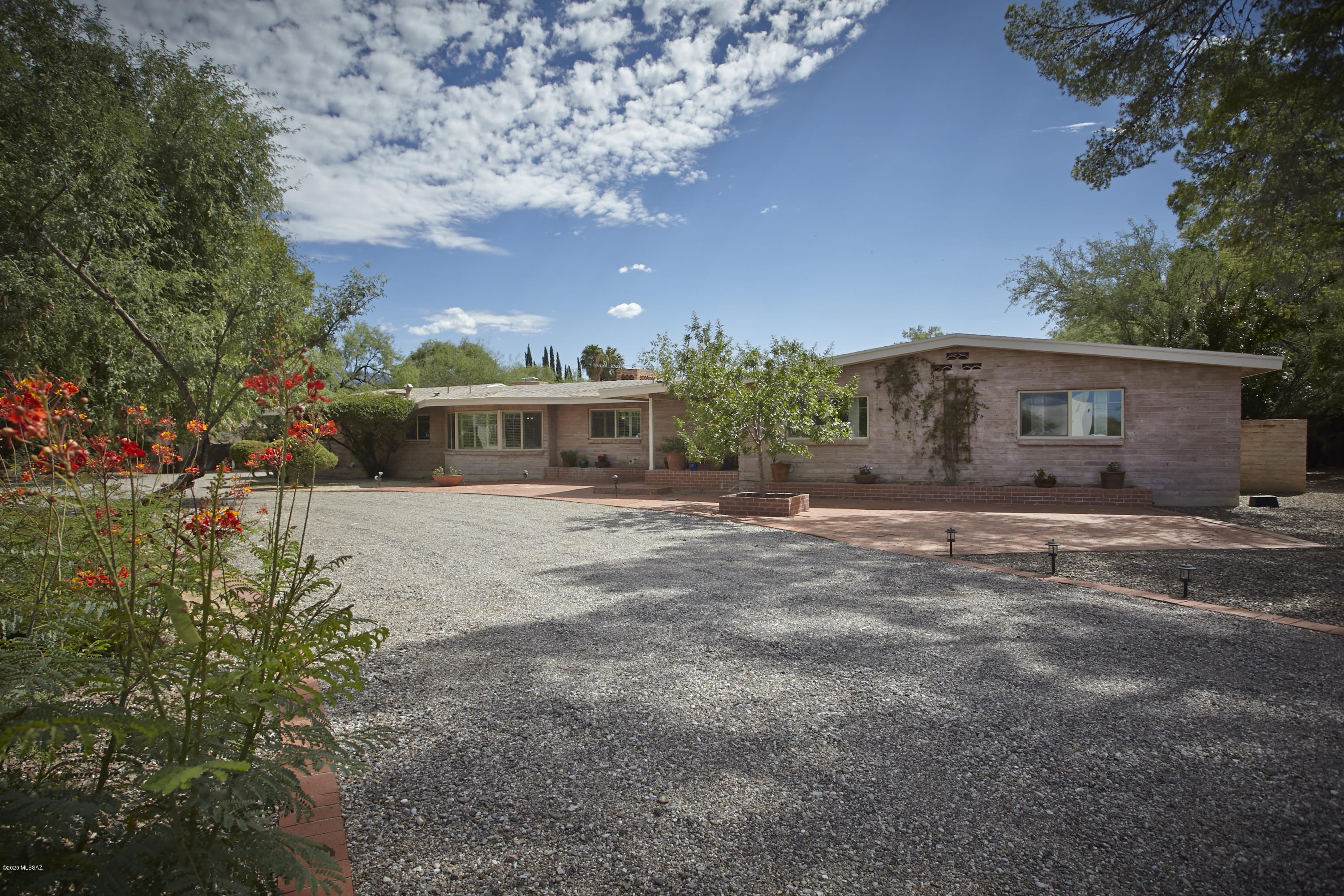 A car collectors dream home in coveted Tucson C.C. Est! This Quintessential TCC home has been recently updated to perfection & has a 5 car garage that will make you the envy of the neighborhood among fellow car aficionados. This 4,065 sq.ft 5BR/4BA home has been updated to reflect the modern day buyer w/a more refined contemporary interior & spacious open floorplan. The gourmet kitchen features a waterfall edge quartz island, stainless appliances & custom cabinets and is open to an adjacent family rm w/stacked stone fireplace & wall of glass doors looking out to the backyard & sparkling pool. The master suite is divine & features a luxurious bathrm & large walk in closet. The large flex space/bonus room is ideal for movie night or a work from home office.  More... The huge backyard w/ expansive brick patios, built in bbq, bocce ball, sport court & fireplace is ideal for social distancing w/the kids or informal entertaining with friends. Updates include Wood plank tile flooring, all new windows, newer mechanicals incl 3 HVAC's & 3 water heaters & newer shingle roof. The Air Conditioned "showroom garage" has brick floors, a workshop area & sink. With the market as hot as the temps outside, this home is priced to SELL!  One owner is licensed to sell Real Estate in AZ.