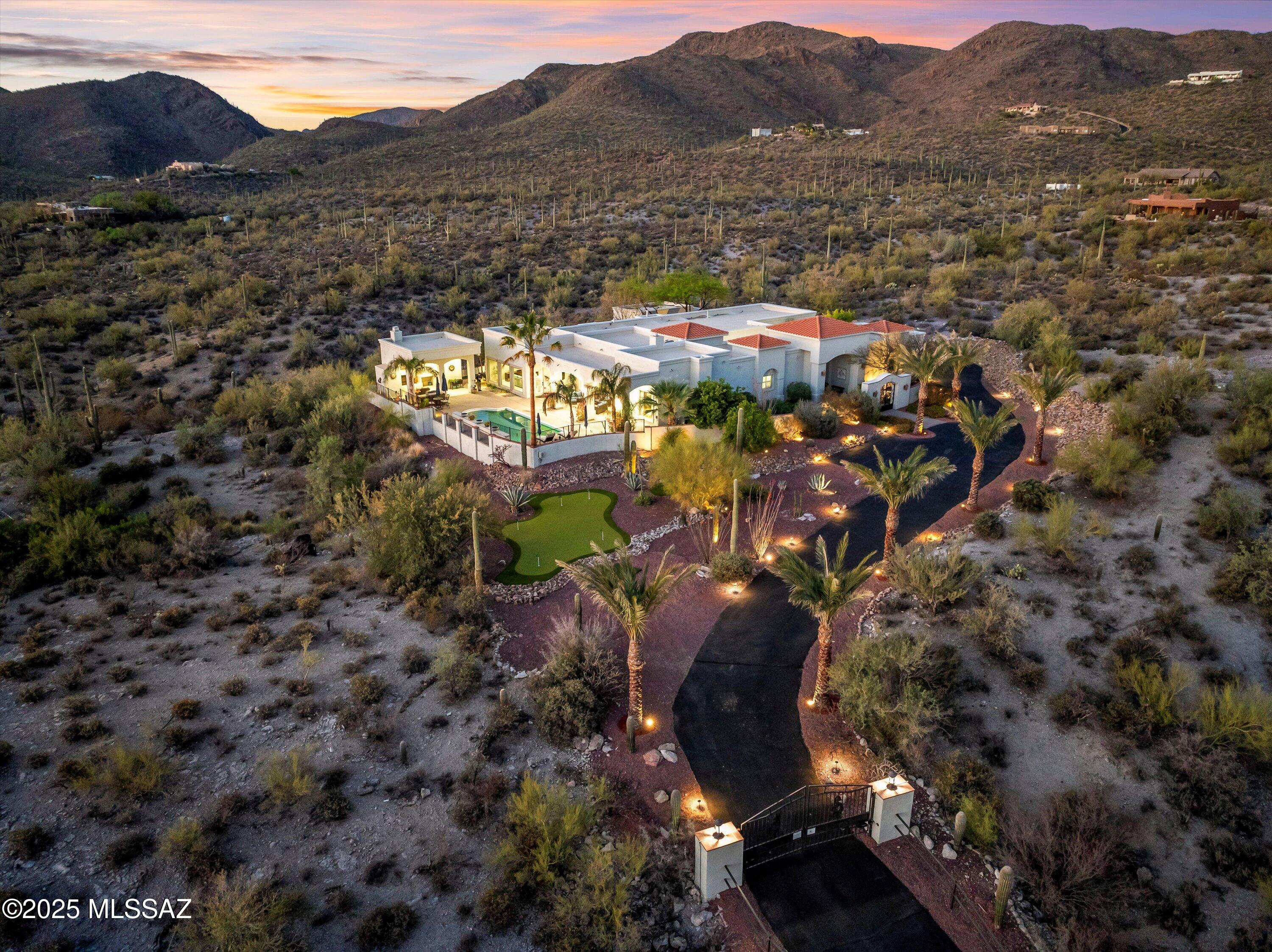 RANGE PRICED to 1.45M. Welcome to your Westside Spanish Mission paradise—no HOA along with privacy you can feel from the moment you arrive. This immaculate estate sits on over 3 acres of natural desert beauty with an electric gated entry, freshly sealed driveway and upgraded landscaping that includes newly planted palm trees, fresh mulch and re-rocked front yard design.

Inside the main house, you'll find 5 bedrooms and 4 bathrooms, thoughtfully designed and beautifully updated. Engineered French oak flooring flows throughout the bedrooms and living spaces, adding warmth and elegance. New windows on the west side of the home bring in natural light and boosting energy efficiency, while brand new Andersen sliding glass doors provide seamless indoor-outdoor living. The primary suite is your private retreat, offering stunning mountain views, double-trayed ceilings, private patio access and dual walk-in closets. The luxurious primary bath includes marble flooring, a jetted tub, shower with dual shower heads, additional spray jets, and a built-in corner bench seat.

The gourmet kitchen is a true showstopper: granite countertops, Sub-Zero fridge, 6-burner Viking stove with griddle, Dacor range hood, stainless steel single-basin Franke apron sink, under-counter beverage fridge, quiet Maytag dishwasher, double GE Monogram wall ovens, built-in desk, island with prep sink + disposal, and a spacious walk-in pantry.

Entertain in style in the formal living room with double-trayed ceilings, a gas-fireplace with stone tile surround, automated sunshades and gorgeous mountain views. The family room features wired surround sound, additional power sunshades, direct access to the backyard and even more mountain views.

The interior bedrooms feature Anderson sliding doors that open into the peaceful, private courtyard with a fountain. Just outside the gates, you'll find citrus trees, the putting green and rose bushes.

Step outside into your personal resort: a large covered patio, unobstructed colorful mountain views, and a completely redone sparkling pool with added waterfall feature. A gorgeous built-in cabana with half bath and fireplace makes this the ultimate entertaining space. The turf area is ideal for pets or play.

The detached guest house (casita) offers comfort and convenience with a full bath, walk-in closet and full-size water heater. A studio-designed space for dining or lounging that features a brand new mini-split for year-round comfort.

Additional upgrades include brand new HVAC systems throughout the property, ensuring modern efficiency and peace of mind.

This one-of-a-kind home combines timeless design with meaningful upgrades in one of Tucson's most naturally stunning settings. Don't miss the chance to make it yours.