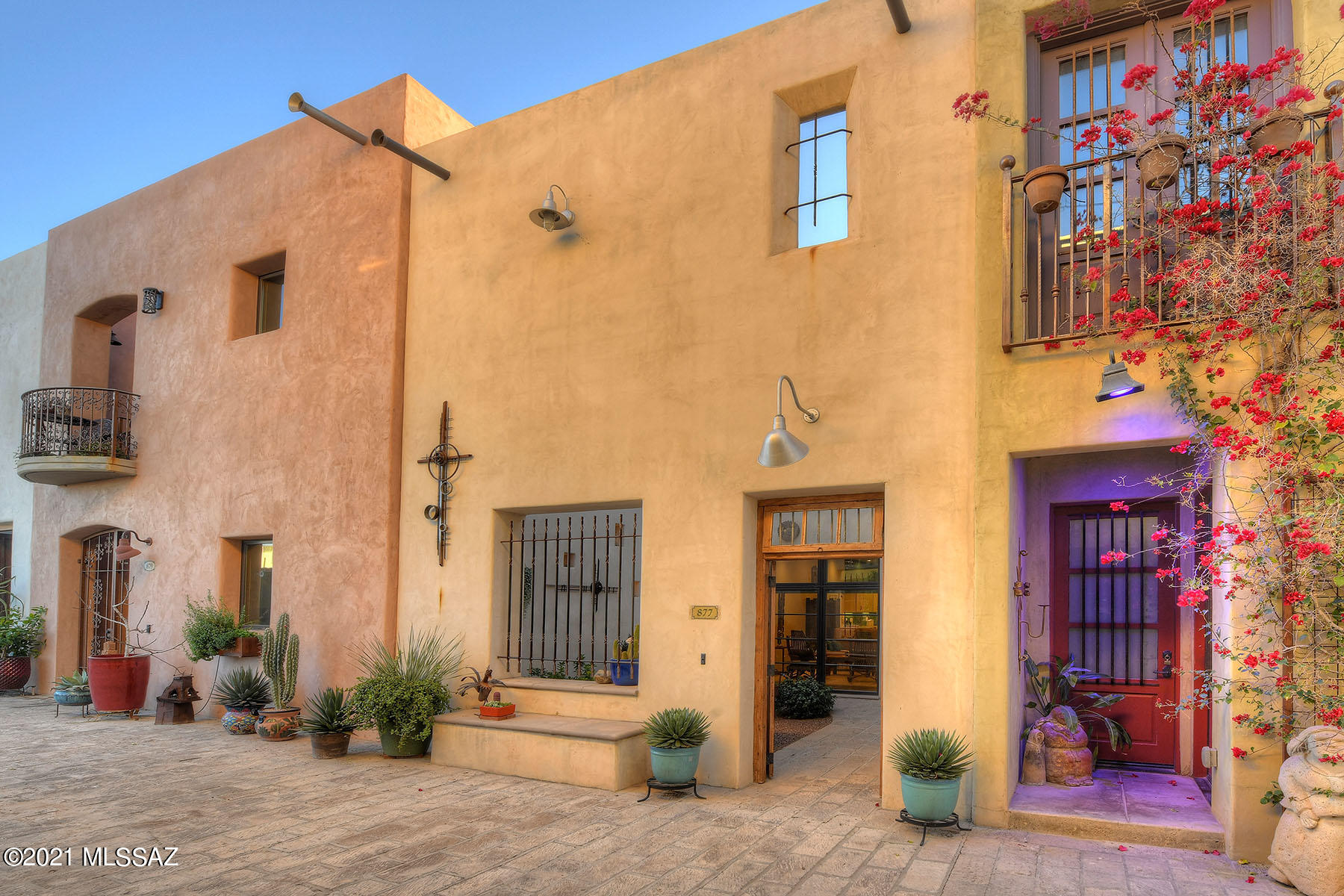 Offering an exceptional opportunity to own a home in a diverse neighborhood adjacent to downtown Tucson. Living near the western terminus of the modern streetcar allows the homeowner to easy access numerous cultural events & recreational activities. The Mercado & Mercado Annex featuring restaurants & shops are just steps away.  Located on a charming Walking Street. Pieces of  Art & lighted nichos adorn an enclosed courtyard  leading to the main level composed of a spacious great room offering living & dining space as well as a modern kitchen ideal for entertaining friends & family. Attached garage accomodates one car & ample storage space. At the top of an artisan crafted staircase you enter the large loft area for office,gym,TV. 2 bedrooms (split design) contains en suite & walkin closets