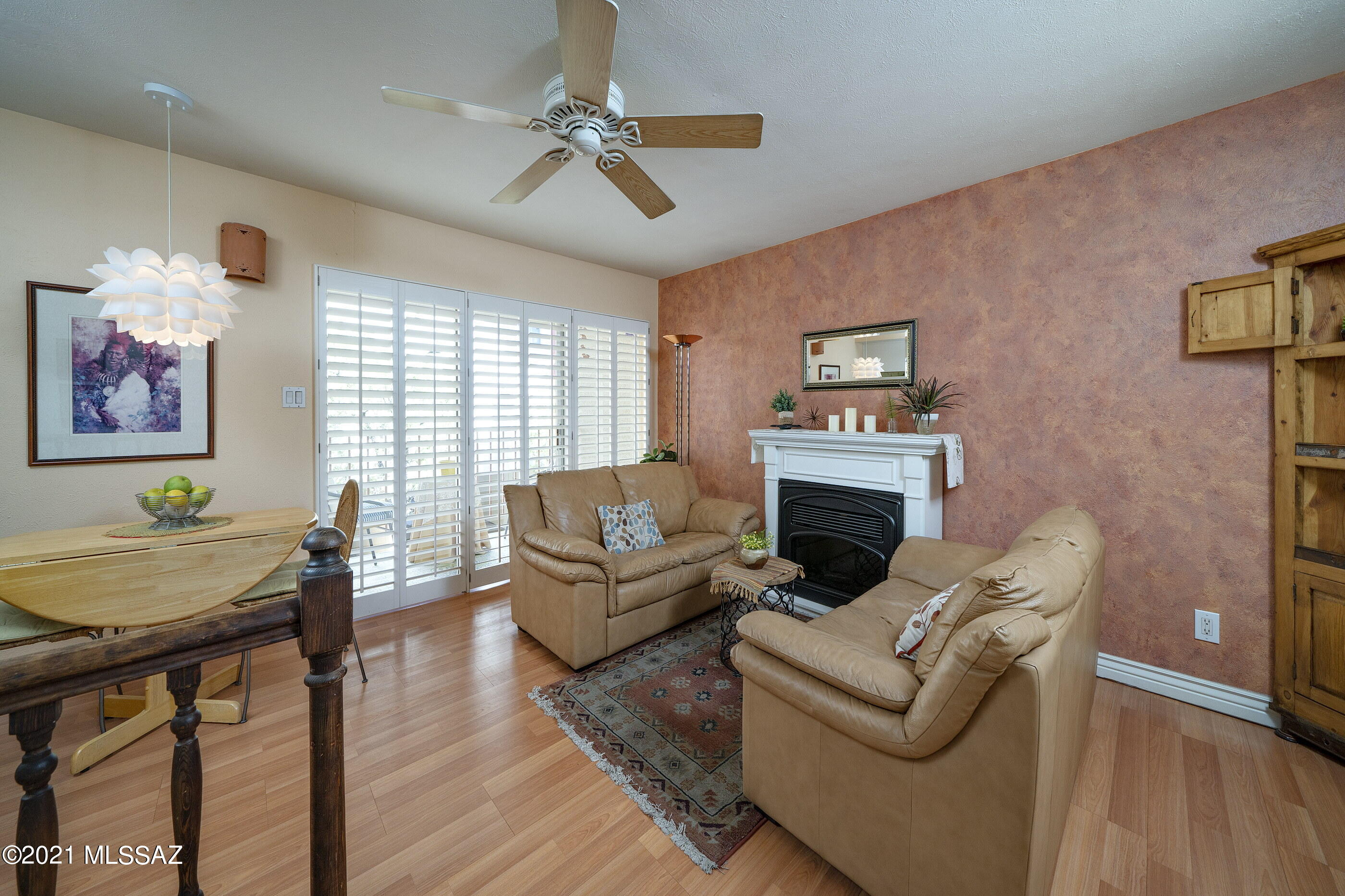 Adorable and charming 1 bed/1.5 bathroom unit in the conveniently located Las Colinas Condominiums. Enter the first level of this private and well-maintained unit to find a comfortable living room with electric fireplace, cozy dining area, updated laminate floors and a beautiful balcony overlooking common area. On the second level, the Master bedroom has a spacious walk-in closet and steps out onto a small, private patio; the master bathroom has a newly installed shower insert.  Attached carport with storage closet. HOA covers water, sewer and trash, community pool, and rec center. No rentals; must be owner occupied.