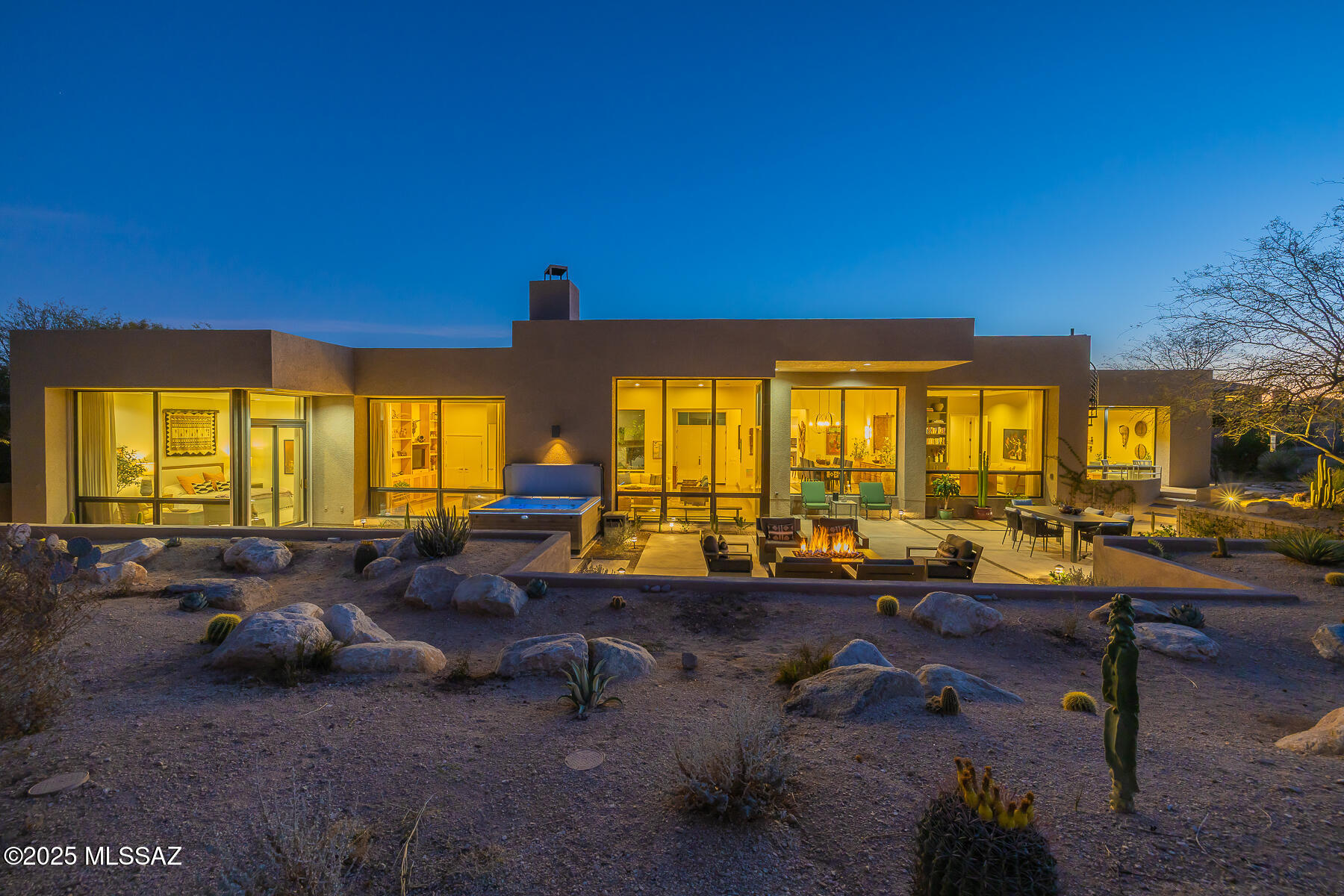 Located in prestigious Ventana Canyon Estates, enjoy spectacular, unobstructed Catalina Mountain views from this beautifully updated single-story contemporary home. Privately set back from the street on a serene .8-acre lot, this property backs directly to hole #8 of the Mountain Course. Thoughtful renovations include a remodeled kitchen featuring granite countertops and new island. The spacious primary suite and bath have been tastefully upgraded, while two additional bedrooms were converted into a dedicated media room and home office. New engineered wood and natural stone flooring flow seamlessly throughout. The back patio has been completely redesigned, capturing breathtaking mountain views and creating generous outdoor living spaces complemented by fresh landscaping.