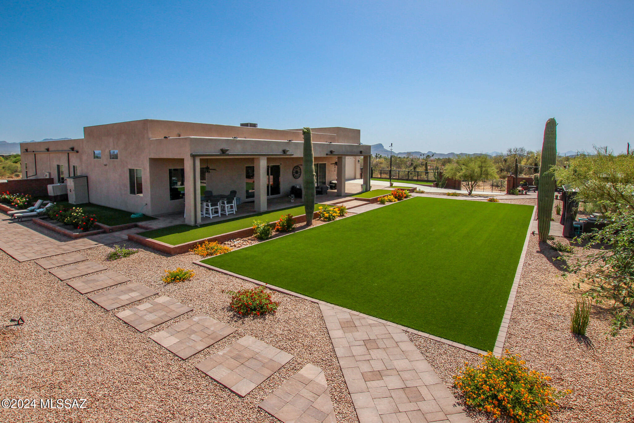 Experience unparalleled luxury in this meticulously crafted custom home, nestled on a sprawling 3-acre estate. Boasting 3 spacious bedrooms and 3.5 elegantly designed bathrooms, this residence offers the ultimate in comfort and style. The Gourmet Kitchen is equipped with top-of-the-line appliances, a dual oven, tile backsplash, abundant cabinets, a generous island and a large walk-in pantry, this kitchen is a chef's dream. The open concept living and dining areas are bathed in natural light, creating an inviting atmosphere for both relaxation and entertainment. 
The backyard features multiple outdoor seating areas that are perfect for enjoying the beautiful Arizona weather and entertaining guests. The property features several majestic saguaro cacti and upgraded faux grass, adding.... to the charm and low-maintenance appeal.
Each bedroom is a private sanctuary with its own ensuite bathroom, ensuring comfort and privacy for all. The primary bedroom boasts a private entry to the backyard, creating a serene oasis. The luxurious primary bathroom features a soaking tub, a separate shower, and ample space for relaxation, as well as a spacious walk-in closet with built-in shelving that provides plenty of storage and organization options. The expansive 3-car garage with extra-long bays is complemented by an additional RV garage, providing ample space for all your vehicles and storage.
Step inside to discover a world of sophistication, with high-end finishes and attention to detail throughout. 
For entertainment, the media room is a true highlight, providing a perfect space for movie nights and gatherings. 
This exceptional property seamlessly blends luxury, functionality, and the beauty of nature, creating a unique sanctuary that you'll be proud to call home.