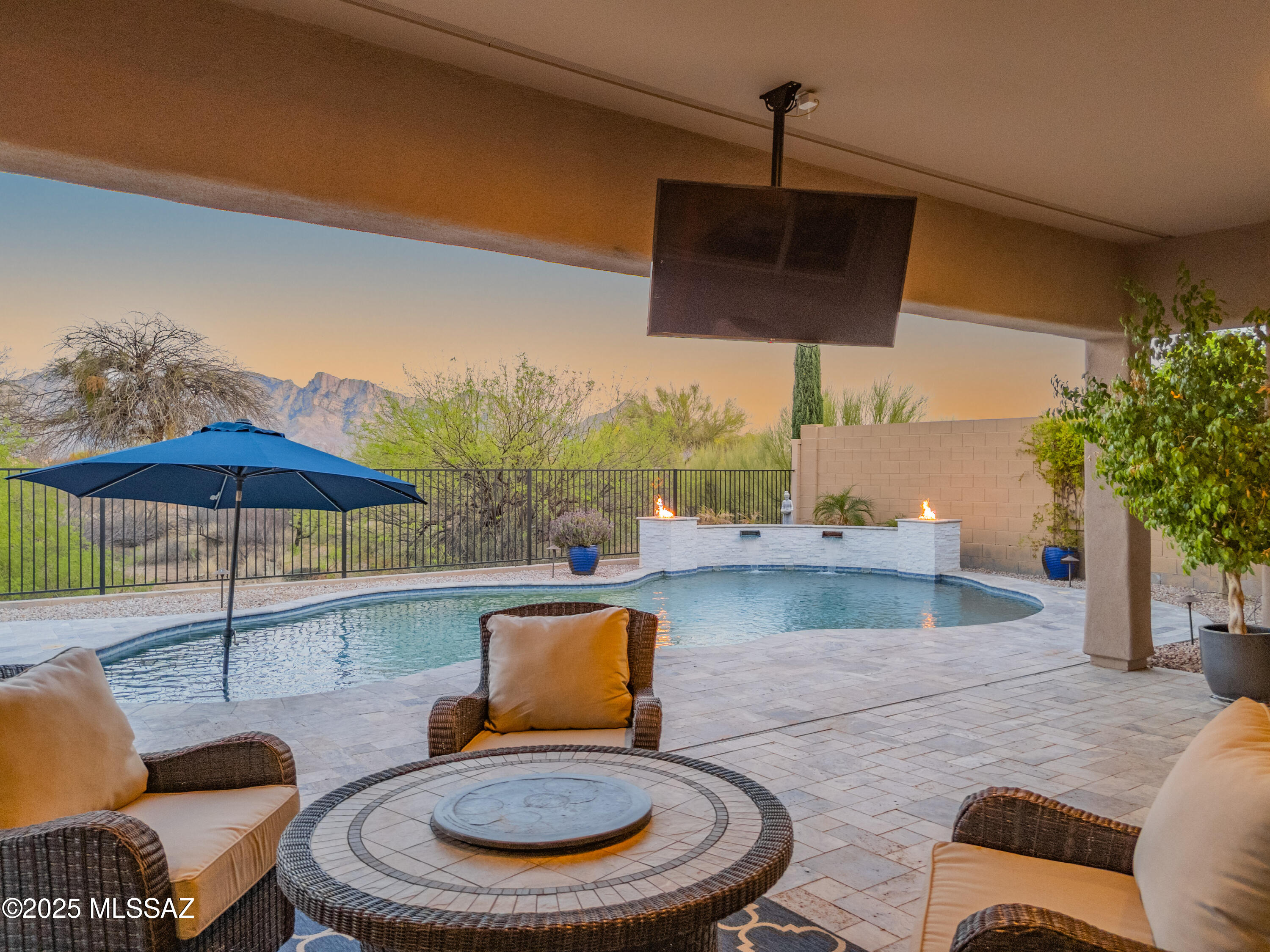COMING SOON! Perfectly situated on a premium lot, this beautifully maintained 4-bedroom, 3-bath home offers truly breathtaking, unobstructed views of the Catalina Mountains—best enjoyed from your serene backyard oasis. Whether you're savoring your morning coffee on the covered patio or hosting an evening gathering, the ever-changing hues of the mountains provide a stunning natural backdrop that makes you feel like you're living in the heart of the mountains. Designed with both comfort and style in mind, the spacious split floorplan features elegant 20'' porcelain tile throughout the main living areas and comfy plush carpet in the bedrooms. The chef's kitchen is a culinary dream, equipped with high-end Sub-Zero appliances including a 42'' refrigerator and a 146-bottle wine fridge, granite slab countertops, Wolf stainless cooktop, double ovens, chrome pot filler, and 42" upper Sierra Vista Maple-Espresso cabinetry.

Step outside to experience the true highlight of this home: an entertainer's dream backyard. The custom pool pairs beautifully with the newly built outdoor kitchen featuring a Blaze grill and dual-tap kegerator perfect for relaxing afternoons or lively get-togethers. And as the sun sets, watch the Catalinas glow in brilliant shades of pink and orange, turning every evening into a desert masterpiece. This view is protected, as the home is surrounded by preserve.

The property backs up to the Vistoso Trails Nature Preserve with hiking trails 50 steps away. Located just steps from the community center and pool, and minutes from scenic trails, The Loop, Catalina State Park, shopping, dining, and entertainment, this home offers the ideal balance of tranquility and convenience.

Don't miss your opportunity to own this one-of-a-kind property where every day feels like a vacation in the mountains.