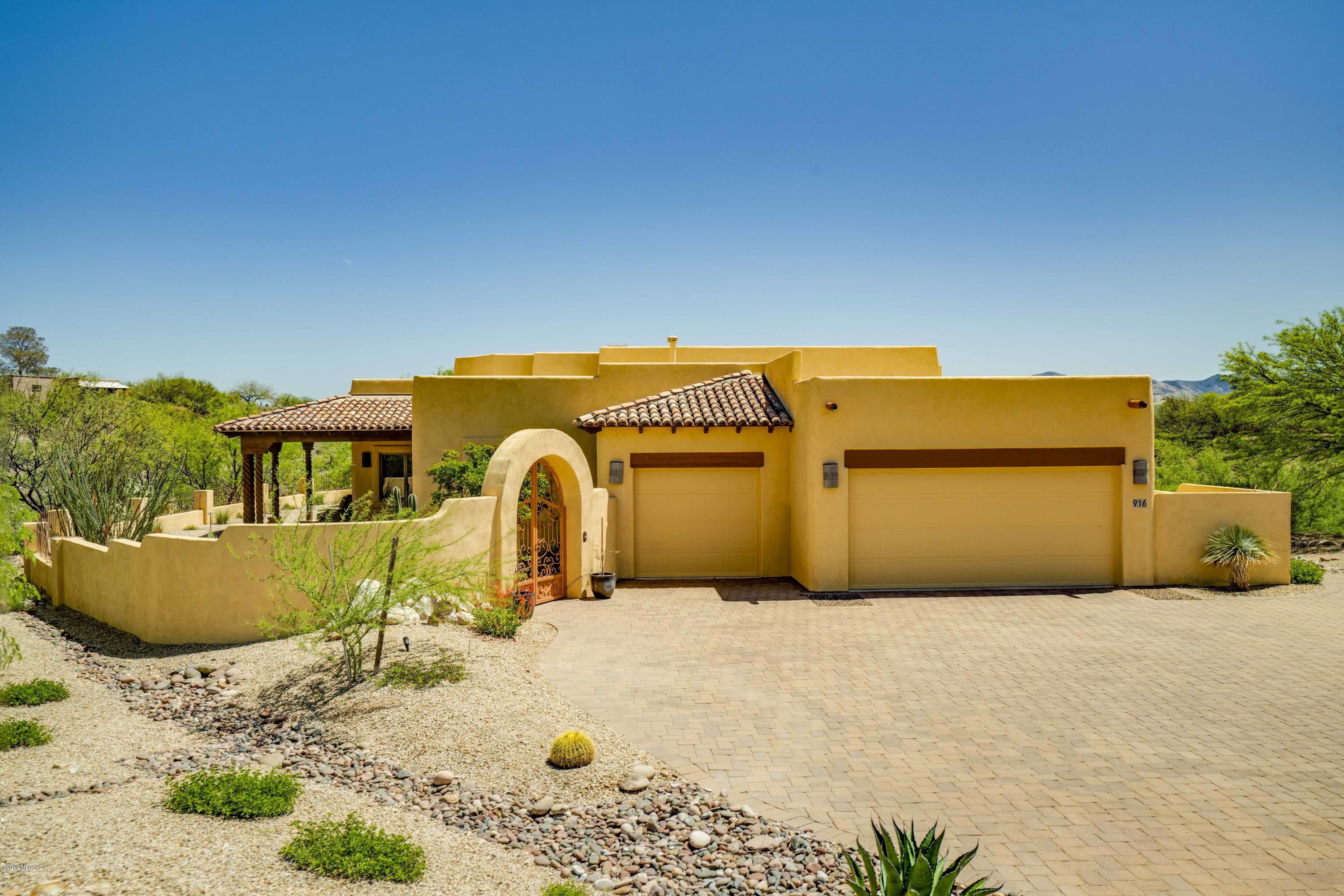From the moment you enter through the courtyard gates you will be amazed by everything you see!  This home is perched on a unique lot with remarkable views in all directions.  Enter through the solid wood door and you'll find spatial elegance where a wall of glass in the great room takes center stage and a corner Kiva style fireplace adds a flare of southwest living.  The traditional dining room displays ornate post and beam décor and a classic recessed ceiling and chandelier.  You've finally found your dream kitchen with dazzling granite countertops, a large prep-cook island, stainless appliances including double ovens, ornate wood posts and Vega beams overhead.  A convenient eating nook is tucked within bay windows displaying terrific views.  Your huge master bedroom suite gives you a quiet sitting area with bay window views plus a garden door providing direct access to the covered patio.  Spoil yourself in luxury in this immense master bath with separate "his and hers" granite covered vanities, custom lighting fixtures, framed mirrors and a curved glass block shower.  Catch up on your reading in the den with electric fireplace, media center and built in bookshelves.  Step outside where the outdoor living spaces are just as incredible!  Sitting on a 1.6 acre lot that is like your own island you will have panoramic views from several sitting areas - choose from the north patio; the covered east patio or the south patio which has oversized glass panels for terrific viewing!  And the 6KW Solar system will keep electrical costs to a minimum.  An absolutely incredible property!