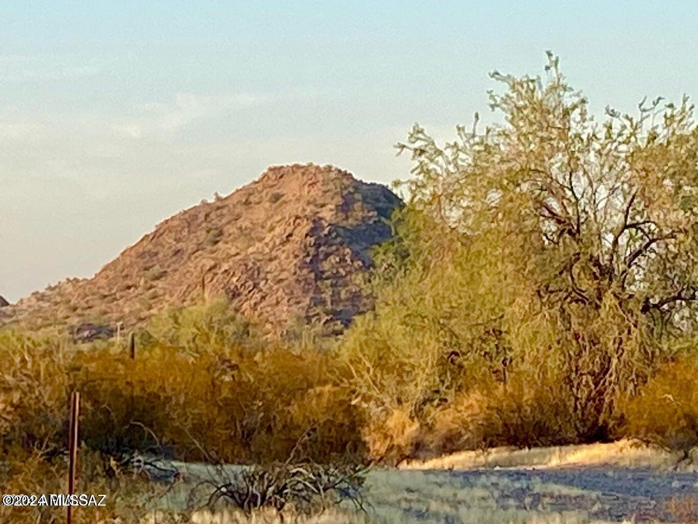 Very private, 1.5 Acres partially fenced, surrounded by mountain views and with no HOA or CC&R's to limit you. Tons of solitude, starry
night skies, tall saguaros and mesquite trees all come with this desert property. Amenities are just a short drive to town. Additional Acreage is available.
SELLER FINANCING AVAILABLE. Survey split in process.