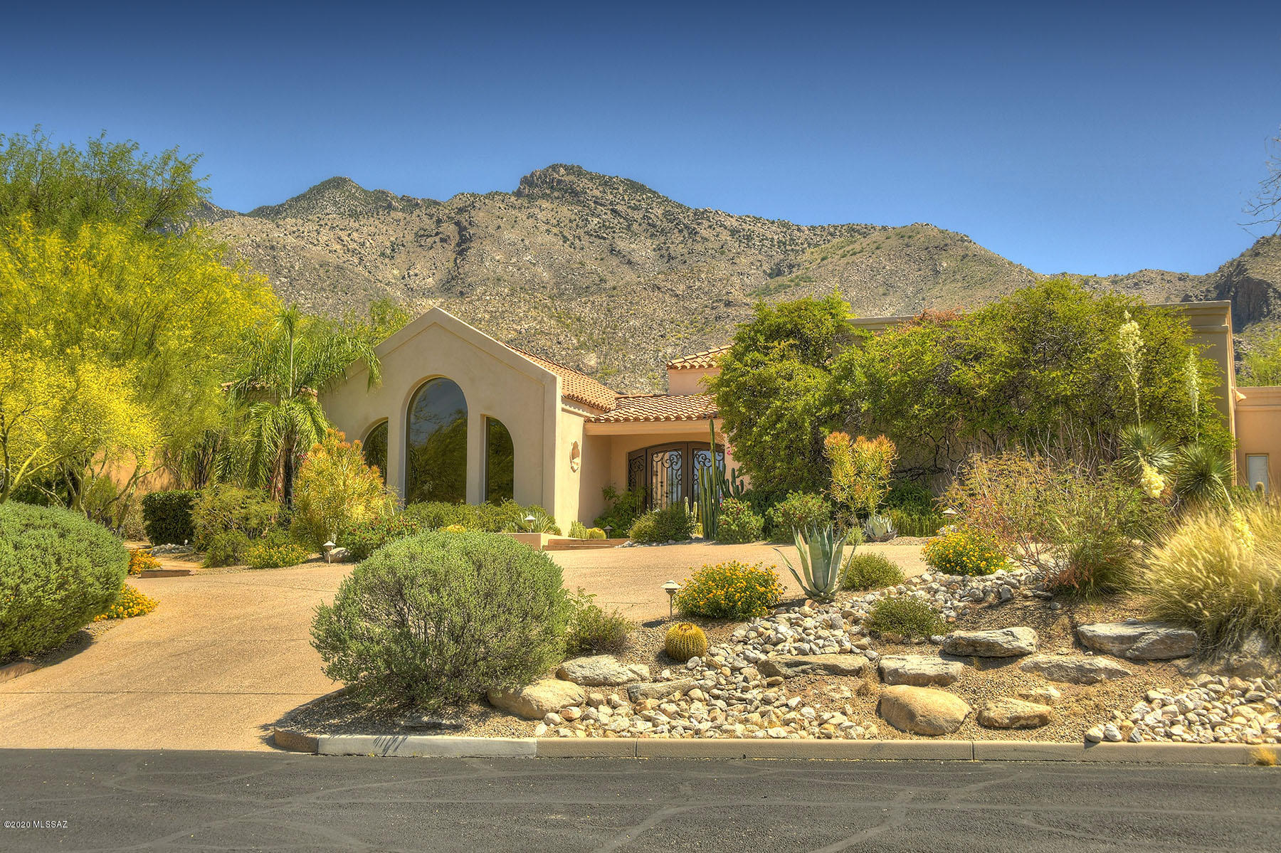 Exceptional Mediterranean home in Ventana Canyon situated on premium golf course lot w/stunning mountain views. This masonry built home offers 4 BRs & 5 BAs – 4448 Sq.Ft. Features include; gourmet kitchen w/hardwood floors, travertine counters, breakfast bar, & Viking/Dacor/Bosch & Sub Zero appliances, great room w/wood beamed ceilings, fireplace & massive arched windows offering spectacular mountain views, elegant dining & living rooms, master bedroom w/cathedral ceilings, sitting area, private patio & mountain views, all guest suites w/private baths & walk in closets, sparkling pool,3 bay garage w/epoxy floors & built-in storage closets,24 hour manned gate. Quality home and the Ventana Canyon lifestyle!