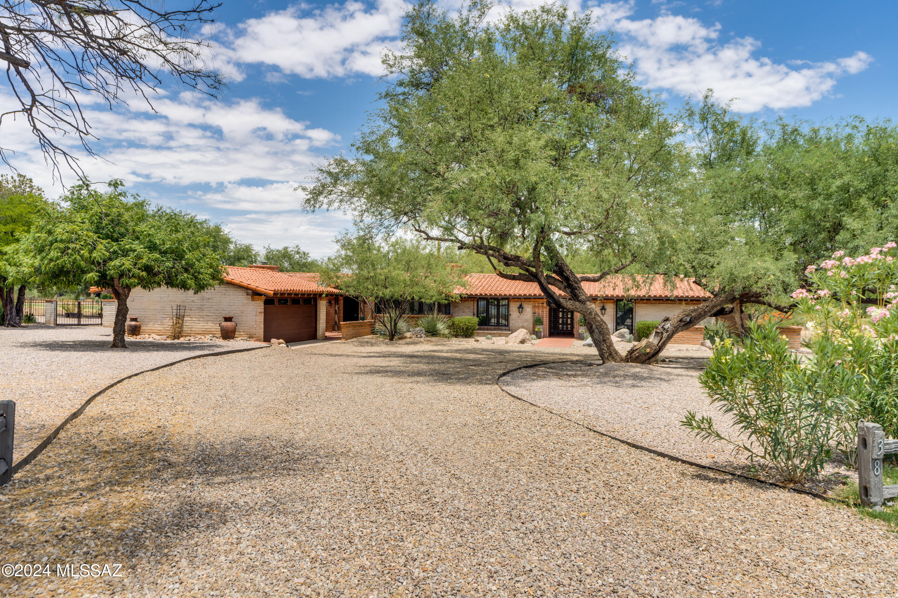 Calling all golf enthusiasts!  This stunning golf course homes offer panoramic views of the first fairway of Tubac Golf Resort's Otero course.  All the golf course has to offer is just around the corner.  Tastefully appointed updates provide modern conveniences while preserving the home's period charm.  The split floor plan places the oversized primary bedroom and a second bedroom at one end of the home.  The primary bedroom boasts two oversized walk-in closets, a separate seating area with a beehive fireplace, and French doors that lead to the private pool.  The guest quarters comes complete with a seating area, a kitchenette, a jetted tub and it's own exterior entrance for additional privacy.  In between is a magnificent great room complete with soaring ceilings and a second fireplace.