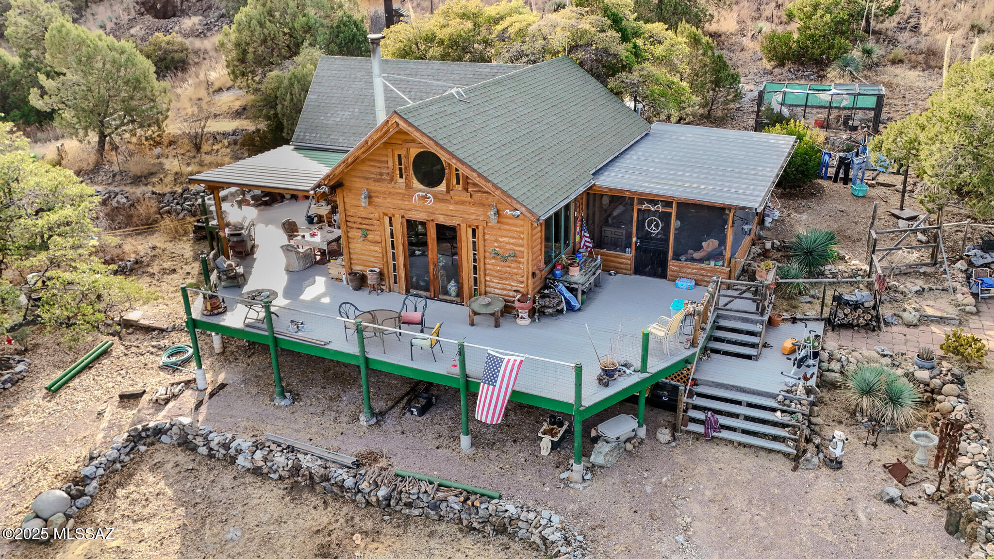 This unique property offers a tranquil and versatile retreat, combining rustic charm with a wealth of opportunities for equestrian enthusiasts, nature lovers and rock hounders. The log cabin, perched overlooking the expansive San Rafael Valley, provides a peaceful and very private gated property, next to the old ghost town of Duquesne. Nestled among 68 acres of trees, it includes horse turnouts, hay barn, tack room, arena/round pen. The current owners have lived here for the past 20 years and have enjoyed the natural water sources & storage, solar power with back-up generators. It has all the modern kitchen facilities, central air and 1 master en-suite bedroom with king size bed, an open loft mezzanine double bedroom and a downstairs bathroom.  Viewing is essential for this property.