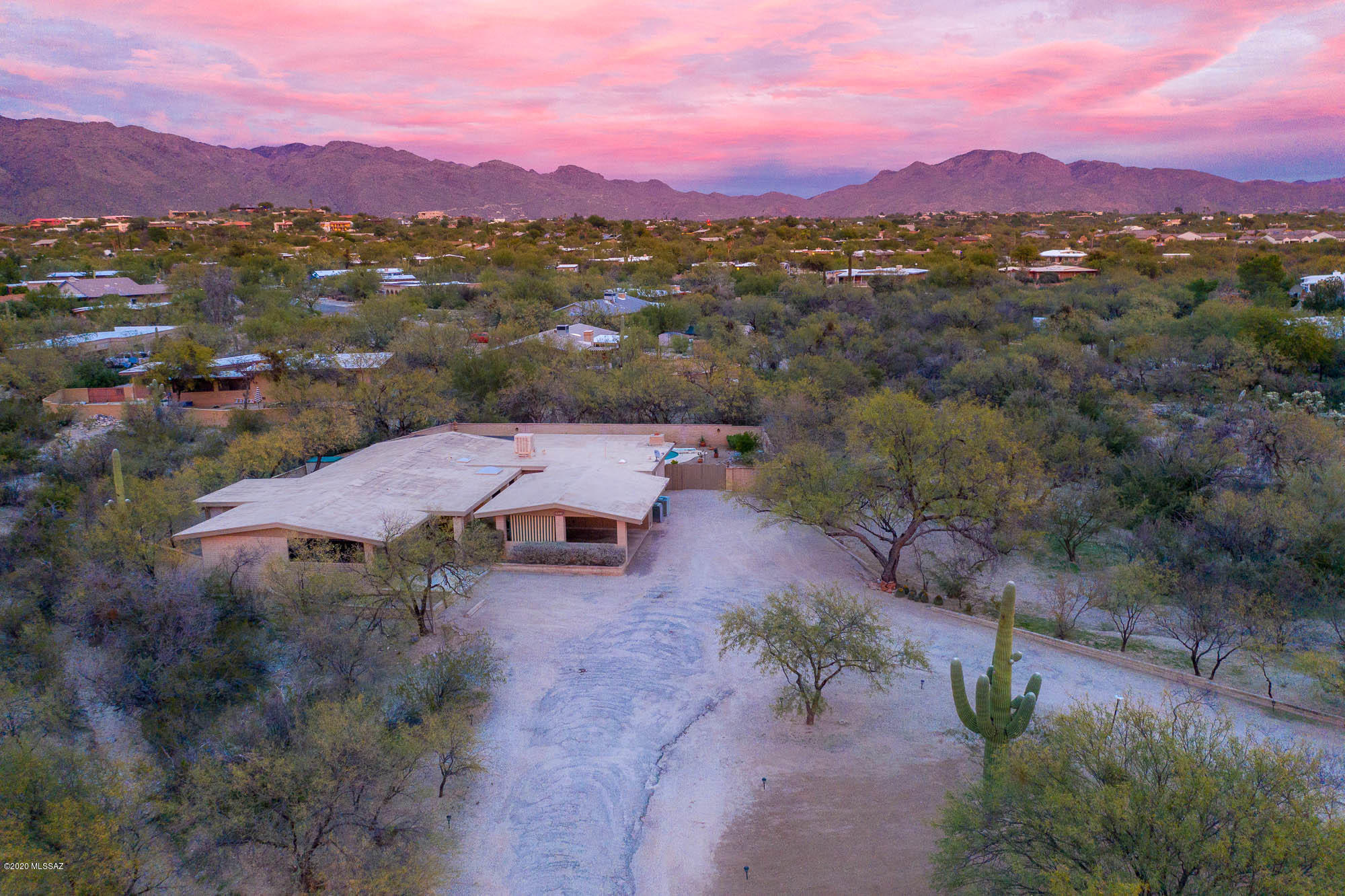 Beautifully maintained single-owner home waiting for your personal touch! First time on the market, this home sits on almost an acre in desirable Tanque Verde Valley, placed nicely off of Harrison Rd. Spacious layout has formal living and dining room plus family room off of kitchen w/ cozy beehive fireplace. Kitchen has ample cabinetry, pantry closet and breakfast bar overlooking the family room. Master bedroom has his/hers closets, dual sinks in the bathroom and private Arizona room. Addition off of family room has den w/ private bathroom, perfect for a home office or guests! Fully enclosed backyard has pool, is well-landscaped with drip system and has exten patio with ceiling fans. Cherry on top is 2 car carport PLUS 2 car garage. Close proximity to Mt Lemmon, hiking trails, & much more!