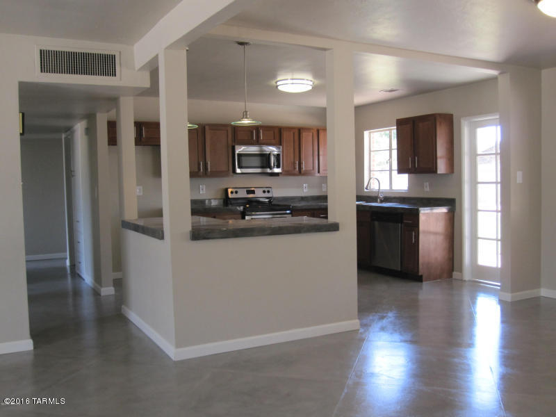 Range priced $170,000-$175,000! Completely Remodeled Eastside home with gorgeous new kitchen, gorgeous concrete countertops, concrete floors, new carpet and list goes on an on. New lighting, fixtures, new roof and AC and beautiful landscaping front an back. The front yard and living room feature Catalina Mountain views. This home is absolutely stunning inside and out. Extra storage, grass on irrigation and a nice covered patio. Call for an appointment to see this fantastic home. A short walk to Park Place Shopping Center, restaurants and entertainment. Davis Monthan, University of Arizona and Downtown are a short commute from the wonderfully located East/Central Tucson home. Extra room could easily be 4th bedroom.