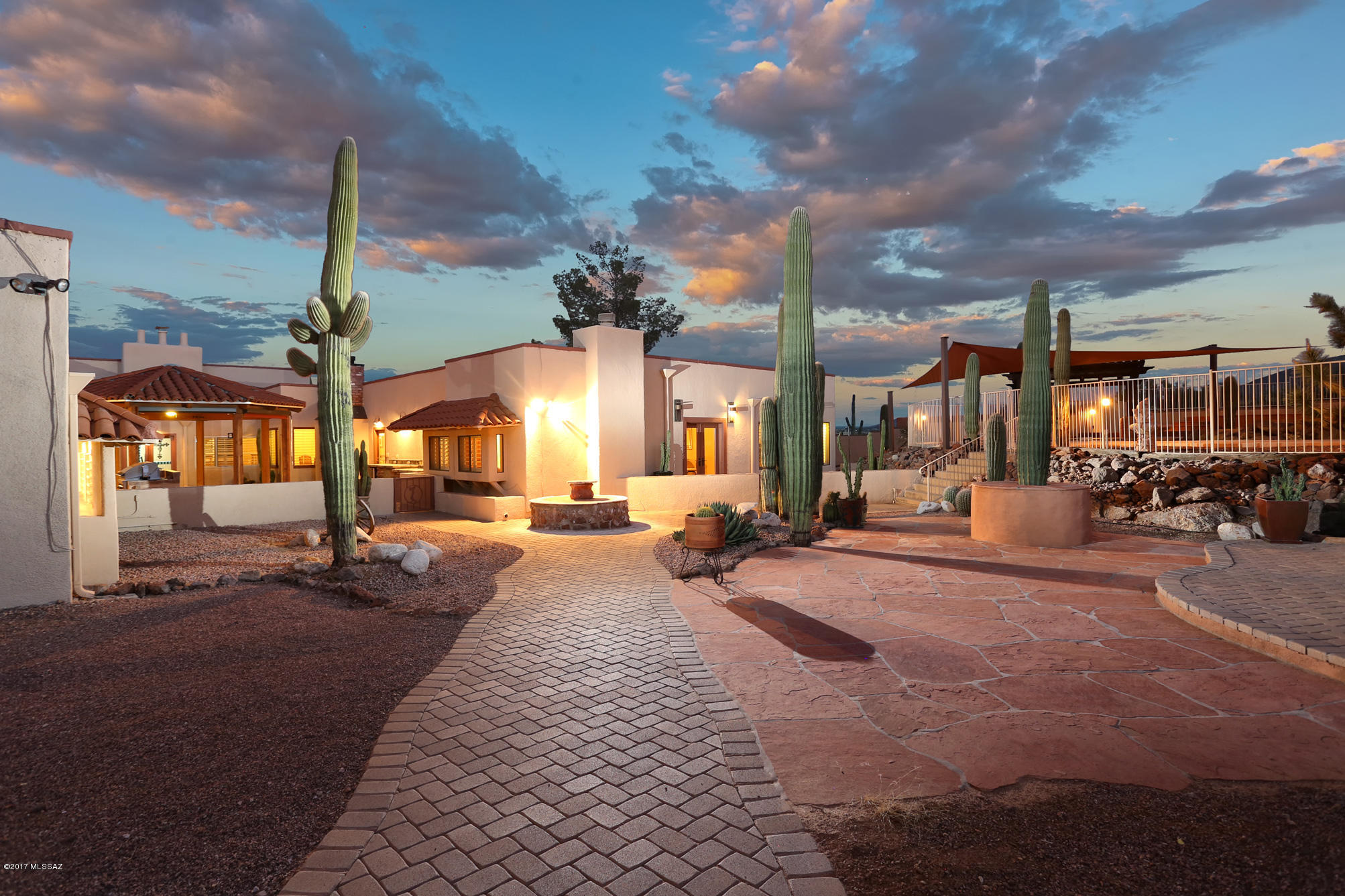 Sprawling Resort Hacienda 5,745 SF 5 BR 7 BA on 6.5 acres. Pictures simply do not tell the story, must be seen in person to truly appreciate the location, views & privacy. Nestled in the Tucson Mountains, enjoy the untouched nature and breath-taking rock formations; your own personal, private, Mountainside get-a-way. Inside, a chef's dream! Gourmet kitchen, granite counter tops, commercial-grade ''Wolf'' stove, ''Earthstone'' pizza oven, spacious island, eat-in nook, formal dining w/ custom granite corner cabinets & arch-way. The attached guest Casita has 2 BR, 2 BA, a Den w FP, kitchen, & wet bar/wine tasting rm! If you love natural stone, you will love this home. A unique Southwestern charm w new ceramic tile, custom int & ext paint & roof w 7 yr warranty. Location is just off Twin Peaks & I-10 interchange for easy access everywhere. Close to Silverbell Park w linked bike trails & sidewalks, Shopping, Twin Peak Outlet Mall, Lehman Academy of Excellence, U of A, & downtown. Total of 6 garage spaces, 3 detached & 3 attached w separate workshop.  Rooftop patio with spiral staircase & office/work-out room. Impressive outdoor features are an entertainer's dream: Multiple outdoor kitchens, grills, patios, decks, beautiful heated/elevated black pearl Pebble Tec pool & spa w/waterfall, creating an unsurpassed outdoor desert oasis. Whether you're looking for a wonderful home & gathering place for friends, a turn-key B and B, or executive rental, the possibilities here are as endless, as the views.
