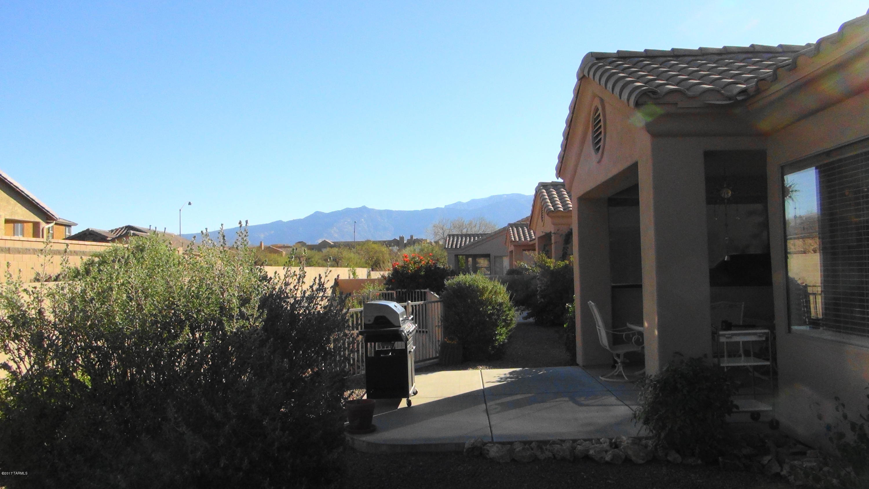 Spacious, shiny & sparkling bright welcome you to this move in ready home. Located in the adult active gated community of Vistoso Village, this Buena Vista model has much to offer. Desirable lot features an extended patio & privacy screen & enjoys an eastern exposure view. Split bedroom plan, w/ great room style living, ceiling fans, security doors both front & back patio.Conveniently located to shopping and hospitals.Other notable features: 2015 SS Kenmore Elite fridge, stove & microwave, solar screens, window tinting & much more.All appliances included.Recreation/community area offers workout equipment & area, library, kitchen, 2 pools, spa & much more. HOA covers landscaping, roof, water, garbage, sewer, basic cable, ext paint, maintenance & pest control. It's all here, waiting for you!