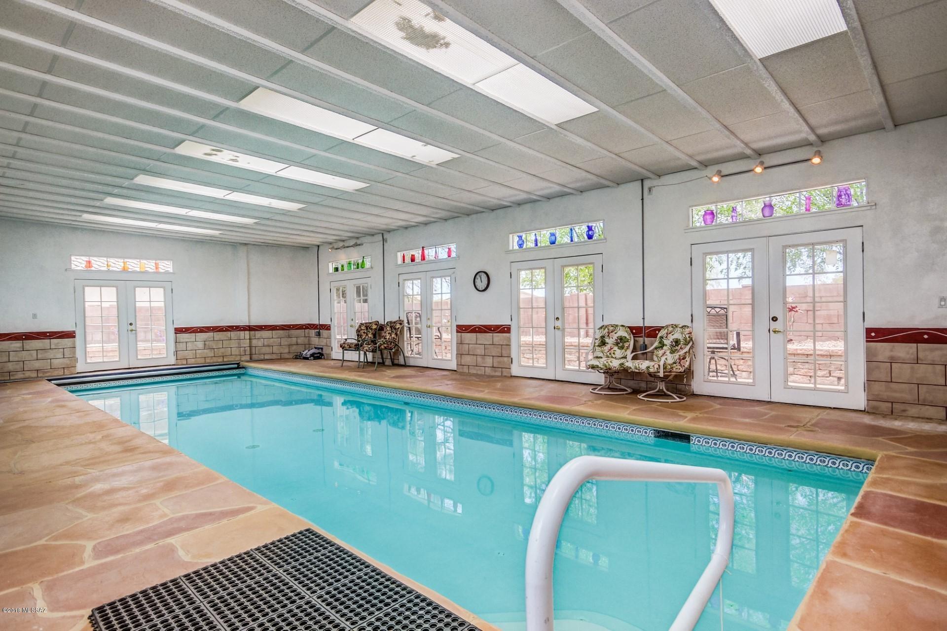 Indoor Pool SANCTUARY! A MUST SEE. One of a kind home! Professional Game tables / lots of furniture included! Granite countertops, Stainless Steel Appliances, Spanish plank tile through the ENTIRE home. This home is impeccably kept- SO unique. No upgrade left undone. Renovated by engineer home-owners who thought of everything. Do you love to entertain? Or just want space for your family to spread out, in a home with open rooms that effortlessly flow into one another. Gorgeous Turf outdoors with as far as the eye can see & PUTTING GREEN, with decked-out cabana and man-cave/she-shed in backyard! Exercise room inside in addition to bedrooms. Huge Game room. Mountain views! New water softener! A MUST COME SEE HOME!
There is nothing like this one!Some Furniture conveys. All game tables include