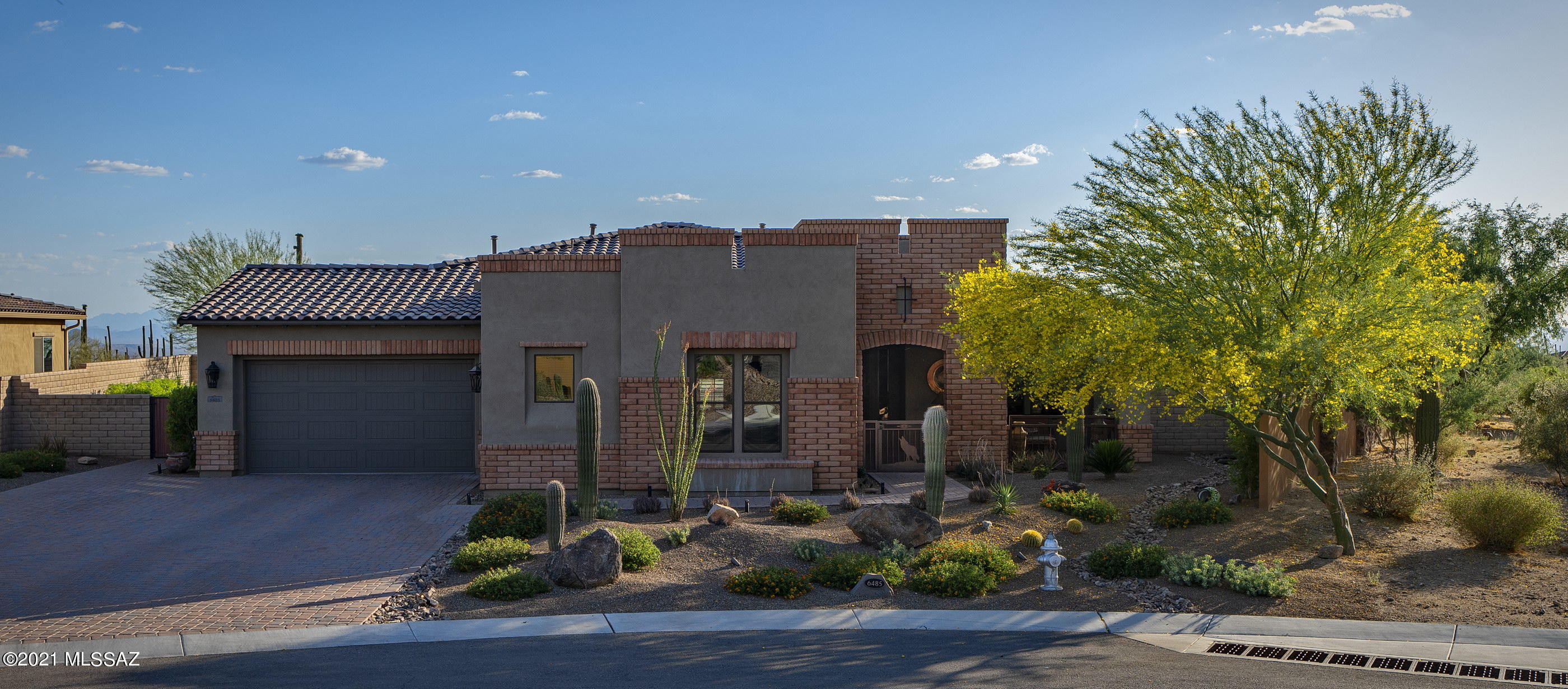 This highly upgraded Toll Brothers at Los Saguaros home is nestled within the heart of Dove Mountain, where resort style living and the High Sonoran Desert work in harmony. Completely custom-designed, this incomparable residence is located behind private gates and surrounded by sprawling and mature desert landscape. An air of grandeur pervades this 3,589 square foot residence, 4 Bedroom, 4 Bath (which includes a Guest Casita), with welcoming tones and textures adding a sense of warmth and depth to the space. 
The main, light-filled foyer opens onto the sophisticated study flanked by the den/lounge, featuring a custom knotty alder bar with wine rack, fridge, & granite counters. The heart of the home is the fabulous chef's kitchen complemented by granite countertops, top-end appliances, and enhanced cabinetry & island lighting. 

The expanded dining area opens onto a spacious Great Room, designed for substantial scale and comfort, flowing seamlessly off the sliding walls of glass to offer an incredible indoor-outdoor living experience. The striking master suite features an expansive, spa-like bath, both voluminous and bright, offering top end fit and finish throughout. 

Enveloping the residence are a number of truly awe inspiring outdoor living spaces, each of which have been thoughtfully positioned to procure the utmost enjoyment of the views and tranquil surroundings. Seamless indoor-outdoor entertaining is expressed through large foldaway sliding glass doors that spill out onto the sun-drenched terrace, offering al fresco dining and an outdoor kitchen with barbecue station, all designed to allow one to enjoy the Tucson Lifestyle.