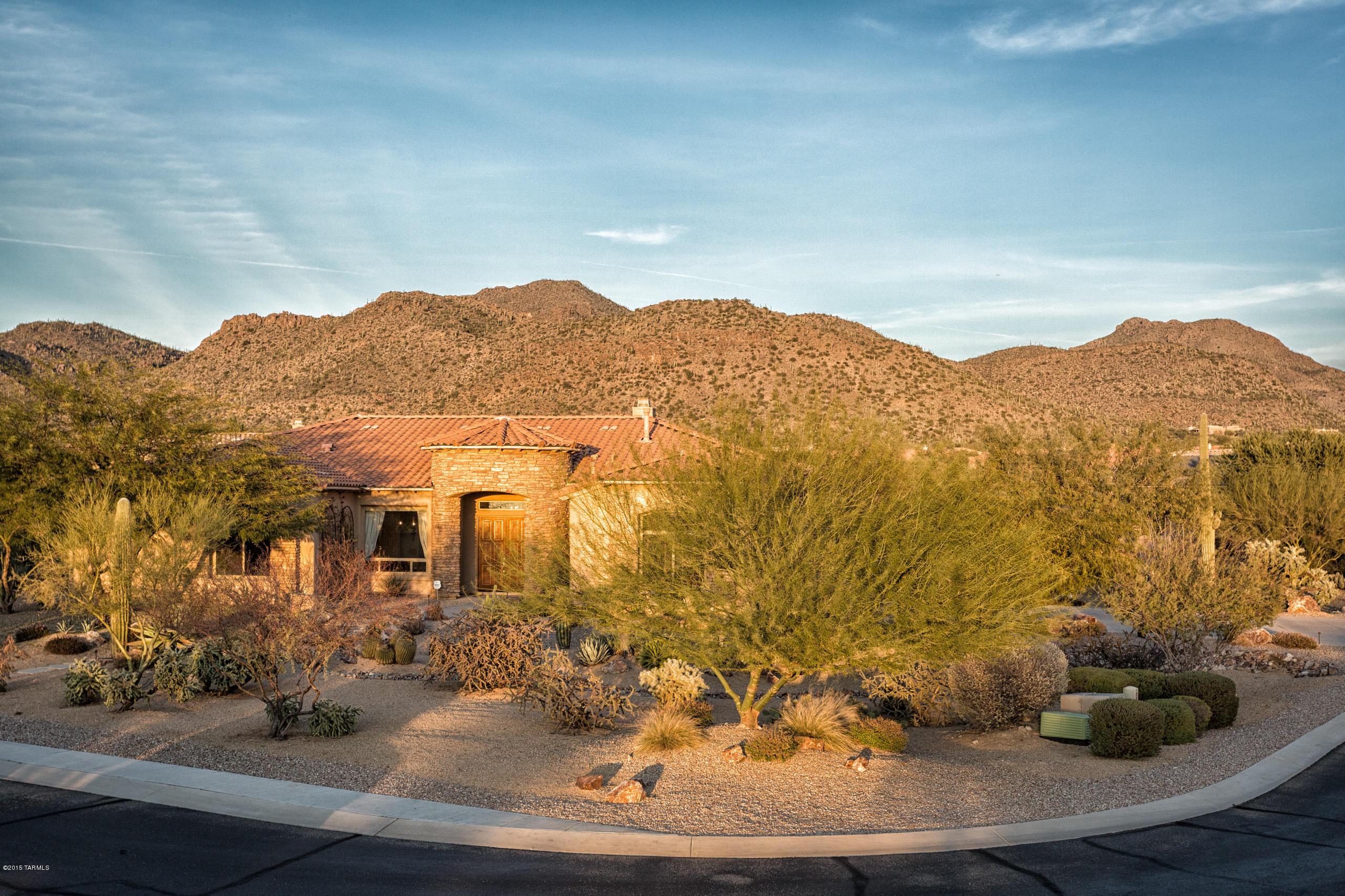 Resort living at it's finest! Incredible luxury in Dos Lagos, Semi-custom homes at Dove Mountain, located on almost 1 acre. This subdivision is surrounded by the Gallery South course. Stunning mountain & desert views w/ privacy. This 3811 (+-) sq. ft AF Sterling plan offers 3 bedroom/media room/den or office plus 3.5 baths. Open flexible floor plan complete w/ gourmet kitchen, stained cherry cabinets, SS appliances, 5 burner gas cooktop, range, warming drawer & wine refrigerator. Granite counters w/ island & 2 counter seating bars surround kitchen. This split plan has master suite w/ 2 walk-in organized closets. Master bath offers glass block enclosure w/stone tile to the ceiling, framed mirrors, tile accents & stone counters. Laundry room has tiled counters & cherry stained cabinets