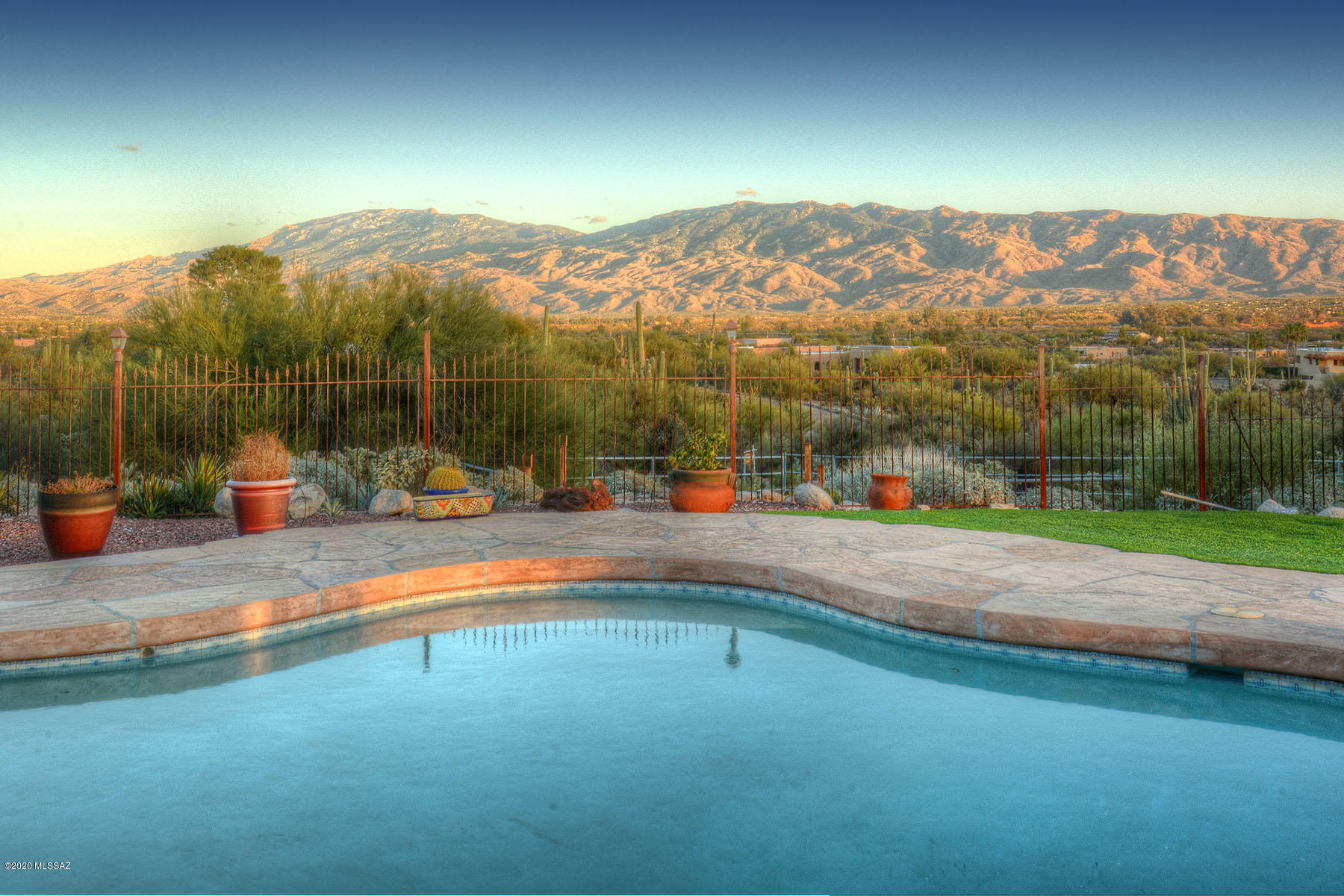 Spectacular City & Mountain Views from this Lovely Burnt Adobe home situated on a Ridge in the Tanque Verde Valley. The 3.45 acre estate includes a 3355 sqft. home plus 1029 sqft. Guest House. Home was Stripped to the studs in 2004 & lovingly renovated w/ square footage added. Great Room w/numerous windows & open floorplan take advantage of the stunning views. Living Room & Great Room feature Custom Wood Ceilings, fireplace & wet bar. Gourmet/Chef's Kitchen w/granite counters, Breakfast Area  & Formal Dining Room. The 3 Bedroom, Main house features a Den/Studio that could be 4th bedroom. Large Master Suite w/extra closet space, jacuzzi tub, walk-in shower & double vanity. Backyard highlights include pool, outdoor kitchen, putting green & Bocce court highlighted by Stunning Mountain Views.