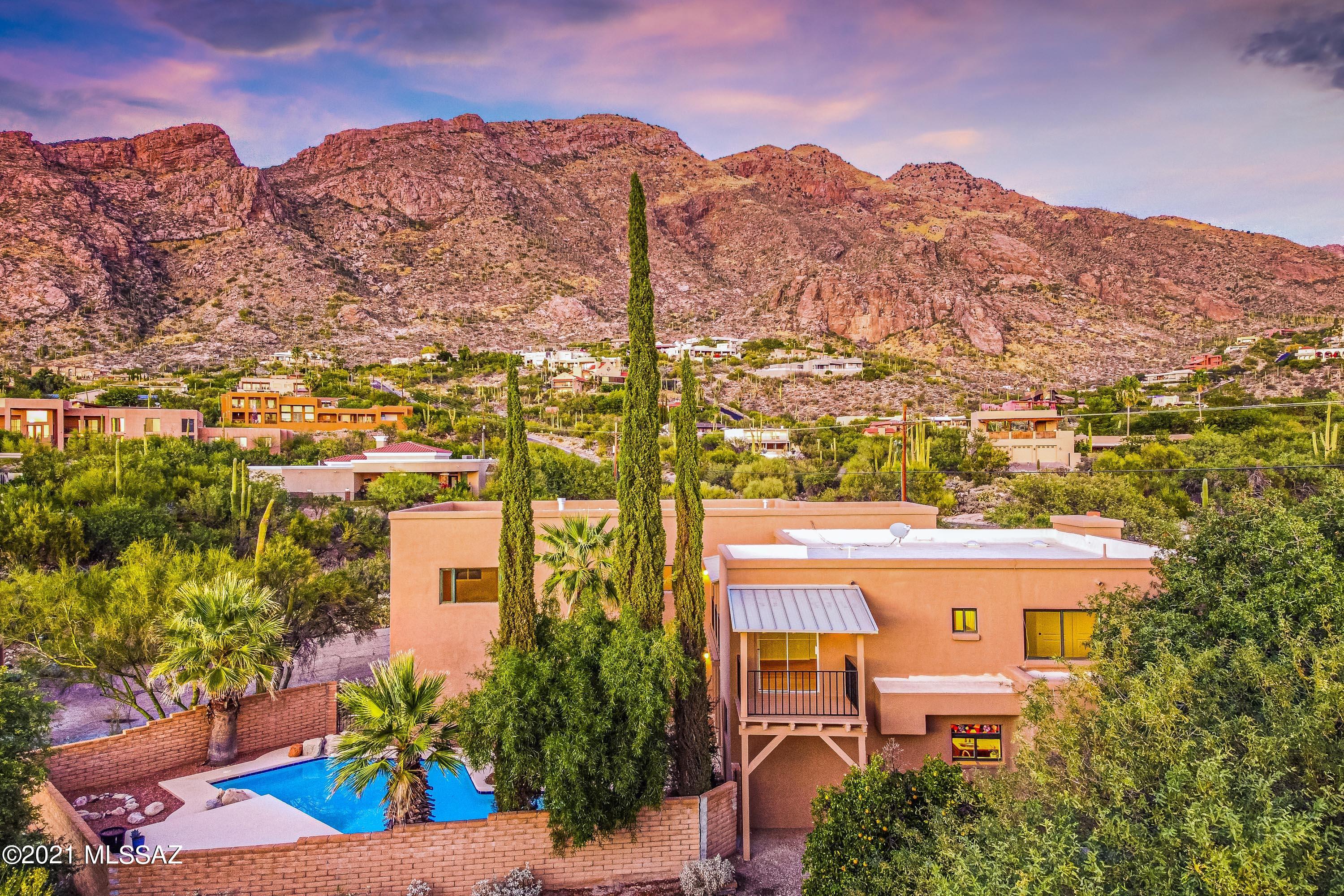 Located at the top of Swan near the base of the Catalina Mountains just North of Skyline Country Club sits this updated 4 bedroom plus den (could be 5th bedroom), 3 bathroom home in sought after Coronado Foothills Estates. A courtyard entry leads to the entry foyer & formal living room w/natural stone fireplace & 20' ceilings. A stunning gourmet kitchen w/granite counters, stainless appliances, island & walk in pantry. Upstairs you will find a spacious master suite with a built in TV over the gas fireplace, city views, a large walk in closet, updated bathroom w/soaking tub & a private covered North facing patio with spectacular mountain views. Also upstairs, you will find two additional bedrooms, a shared bathroom & huge loft area