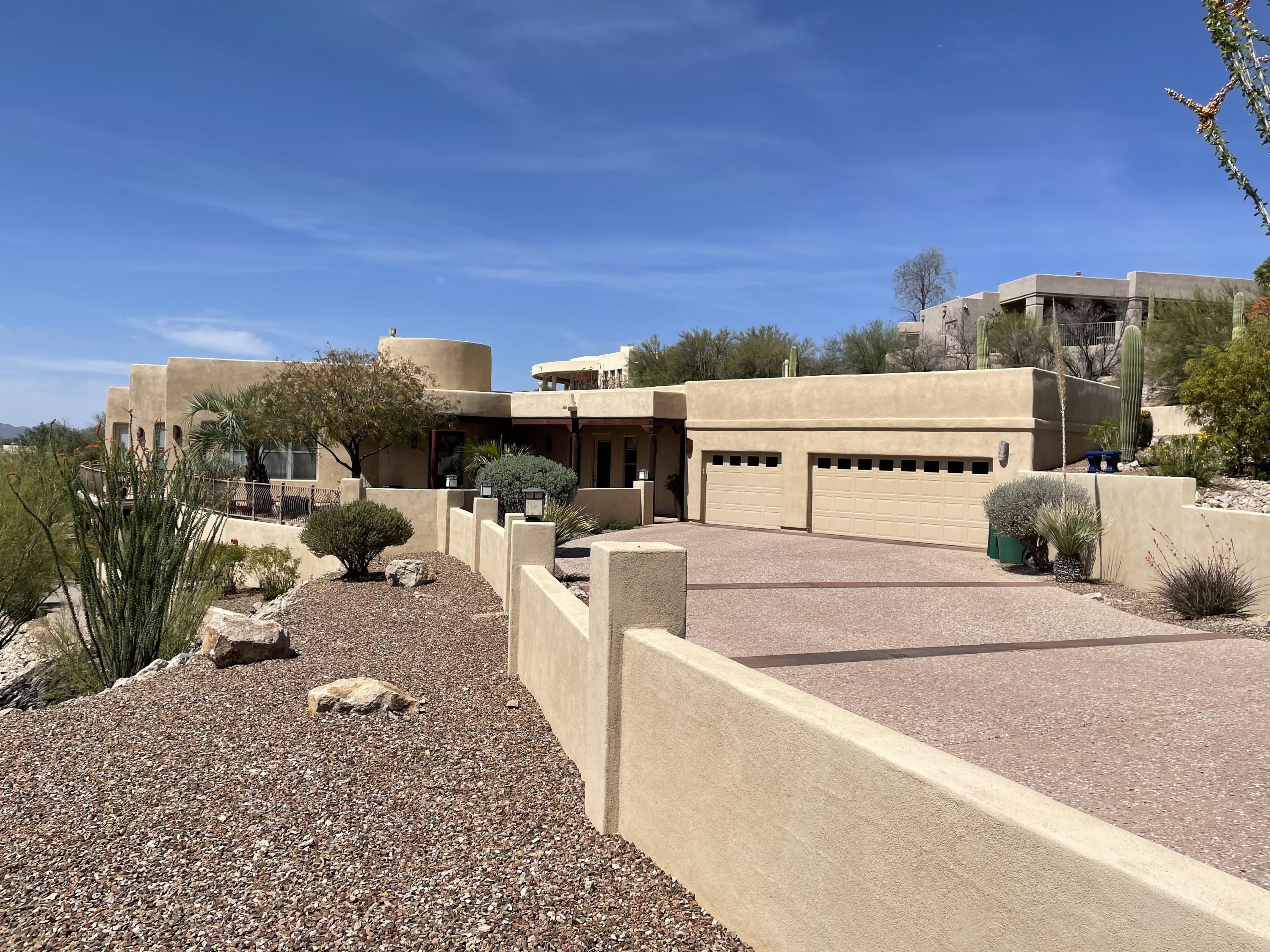 Mountain and City views in this gorgeous southwest custom designed home. Travertine tile & light maple wood & marble floors adds a contemporary touch to this to this Southern Arizona styled home with beam ceilings.  Master BR has beehive fireplace off tub, double vanities and well planned walk in closet.  Exercise room has steam shower & space plumbed for sauna; could be office or converted to BR. Gourmet kitchen w/custom high end stainless steel appliances, pot filler over gas cooktop with grill and twin oven area, convection oven & granite counters, central vac,  The lower level has loads of space and could provide generous living area for mother-in law/family members.   Range Price Listing; Seller will accept or counter offers between $1,000,000-1,150,000.