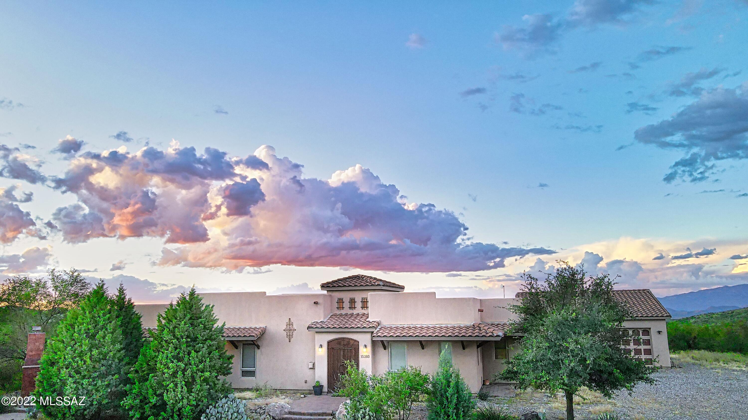 ***Seller willing to negotiate Concessions***Peace and Tranquility await you on a 10.32-acre desert oasis. Enter the Grand Foyer to experience all this home has to offer. A gourmet kitchen outfitted with custom cabinets, Jenn-air appliances, and tons of counter room on the granite countertops. The open floor plan and large windows capture the stunning mountain views. The primary suite features a large bathroom with custom tile work, two walk in closets and a bay window. The Great room has a gas fireplace with hearth side seating and is wired with a speaker system. Spacious bedrooms with lots of light and closet space. Additional room could be a den, office, or 4th bedroom by adding a closet. Adventure and relaxation abound from horseback riding in the arena relaxing in the salt water pool, eating dinner by the outdoor fireplace watching the sunsets or watching the stars from the studio/observatory. Attached garage can fit 6 cars plus there is a workshop with 220 electric. The home is handicap accessible and designed with wide hallways, doorways and no interior steps.  Vail School district. Within 20 minutes to shopping, restaurants, and I-10.