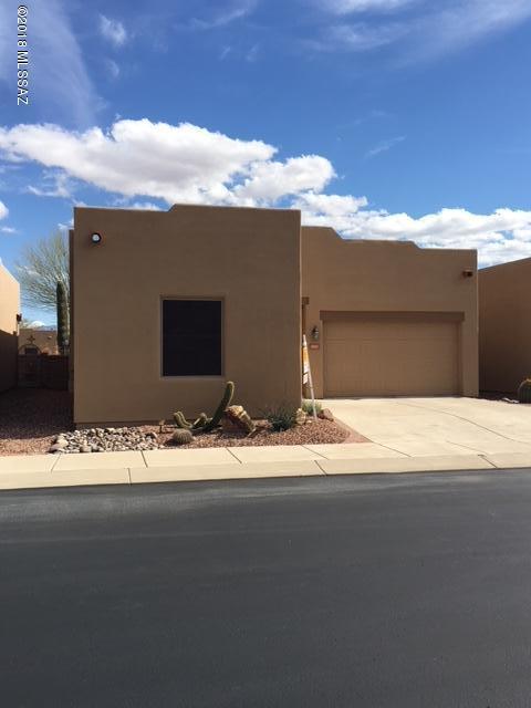 An excellent opportunity to live in The Springs at Santa Rita, a highly desired adult community, conveniently located in Green Valley with easy access to Tucson. The town-home is actually a free standing home with no attached unit on either side. The split bedroom floor plan has two suites, a large living area, a built-in side buffet/storage unit in the dining area, breakfast bar, plantation shutters, ceiling fans, wood laminate/carpeted flooring throughout. Nice view of the Santa Rita Mountains from the back covered patio. Additional awning provides more shade. Part of the Green Valley Recreation HOA in addition to The Springs HOA. Many amenities and a pool/rec center are part of living here. A small park is in the community as well as a nice walking path through the desert. Come see this great home today! Be prepared to fall in love!