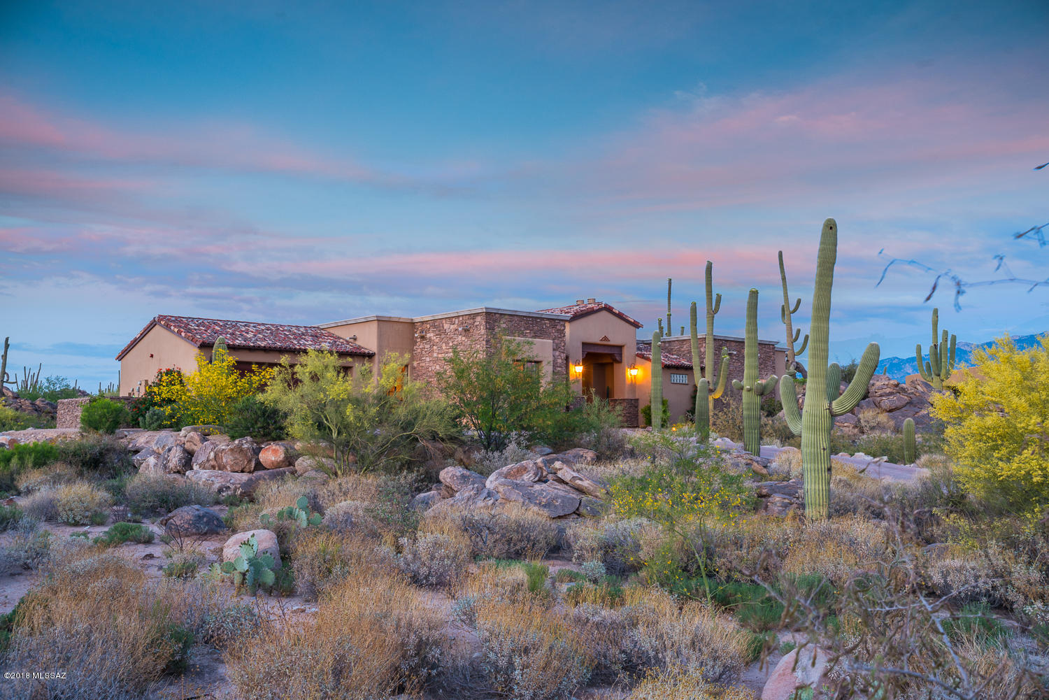Privately nestled amongst incredible rock outcroppings and gorgeous saguaros. Feel quiet and tucked away in your own getaway. Easy lock and leave or year round home. Great room open floorpan concept with split room layout. All the beautiful finishes one would expect in a custom home including a gourmet kitchen with large prep areas.  Entertain with a seamless indoor/outdoor experience with the triple panel disappearing door. Grand Master BD & BA with large W/In Closet. Windows in every room provide a different incredible view in every direction. Enjoy the Stone Canyon lifestyle of fitness, world class golf and social activities. Tour of this home and amenities available 7 days a week. Adjacent Parcel also available for sale MLS#21804806.
