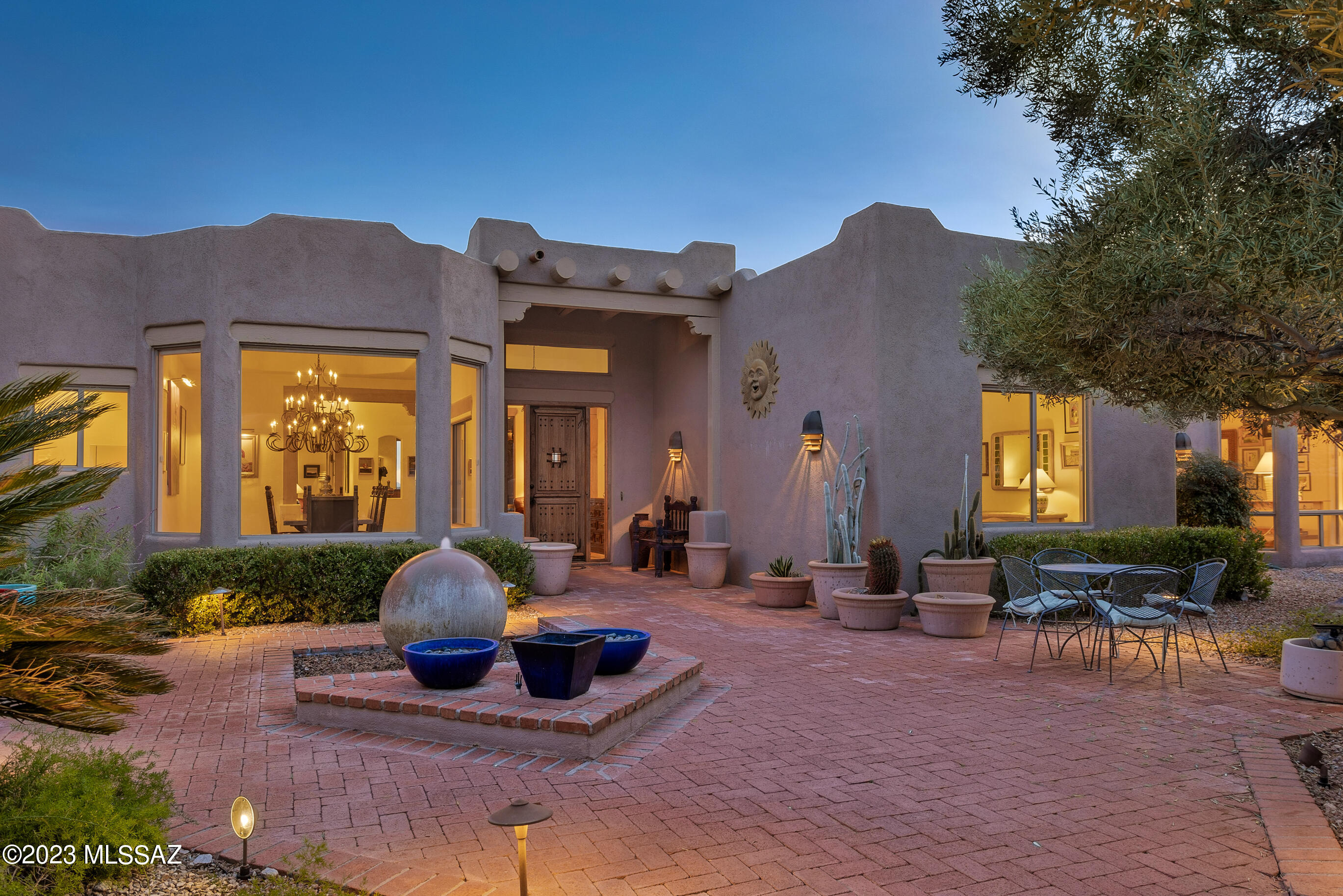 In the heart of one of Tucson's most desirable guard-gated foothills communities w/ easy access to central Tucson, La Encantada, + daily shopping just minutes away. As you approach this stunning home, in a quiet culdesac, enter through a custom gate to the tranquil, beautifully landscaped,  courtyard featuring a calming fountain + sitting areas leading to the 8' mesquite front door. This impecable hacienda w /split 4 bdrm  plan, formal liv, dining rooms + large master, and a second ensuite bdrm .The cook's kitchen w/ center island is adjacent to a bkst  nook +large fam.rm with beamed ceiling, FP + sweeping city views.. Large heated pool and spa overlook the valley + mountains during the day + evening city lights + glorious sunsets!  Large  covered rear porch w/beamed ceiling + Kiva F