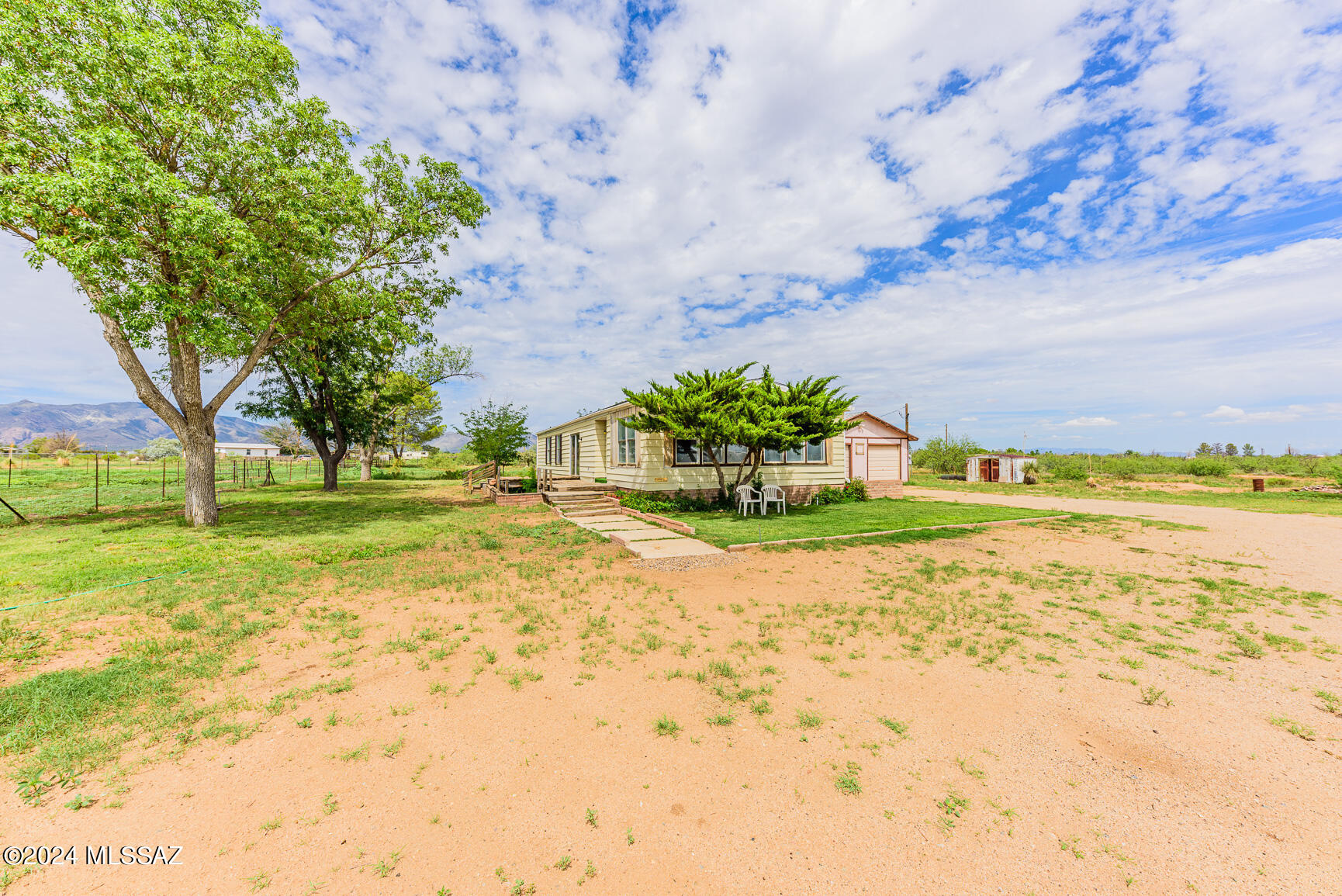 Great 4.9 acre homestead!  Plenty of room for livestock and gardens.  Large multiple room office and/or den space attached to a large 2 car garage.  Spacious 2 bedroom and 2 bath with a laundry room and walk in pantry.  Fenced and gated, mountain views and seclusion are what comes to mind.  Wide open space potential!