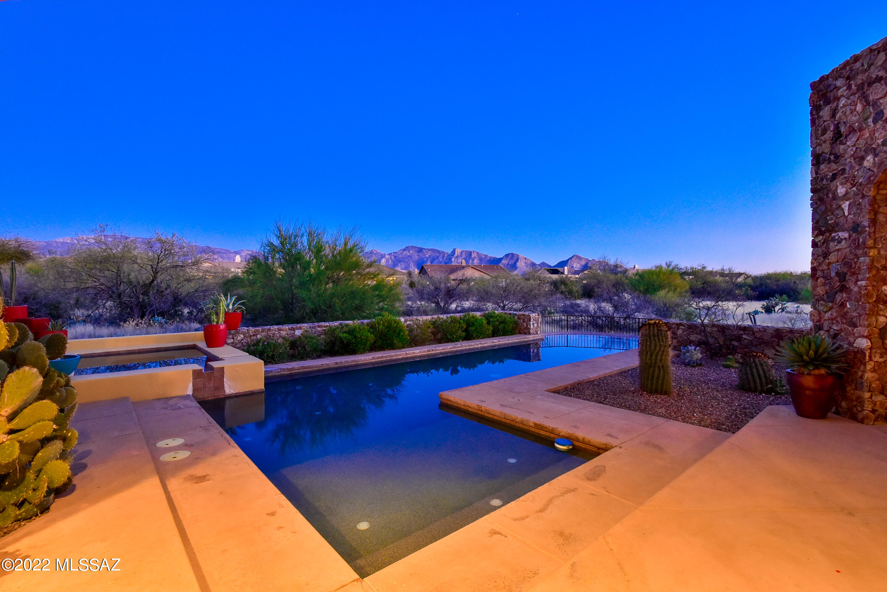 Tuscan inspired masterpiece within the exclusive Stone Canyon community. Designed by Ron Robinette & built by Mark Alan, this beautifully appointed home boasts wood floors, huge wood beams, knotty alder solid doors with iron hardware & slab travertine counter tops. This elegant home has an open kitchen with upscale finishes such as a Viking stove, Sub-Zero wine coolers & refrigerator, wood countertop chef's island, custom cabinetry & upscale travertine backsplash. Enjoy the tranquil outdoor space /c large east-face covered patio, lap pool, soothing spa & travertine tile patio. Pure bliss is realized in the oversized primary suite /c fireplace & french doors for easy access to the pool/spa. Lavish in the primary bath in the luxurious shower, walk-in closet & double vanities. Brand pool heater, new dishwasher & one HVAC unit was replaced Nov. 2020. Most furniture is available for separate Bill of Sale. Call agent for full list of amenities, and a personal tour of the home & the Stone Canyon Club: featuring world class golf & fitness facilities, dramatic clubhouse with restaurant & bar.