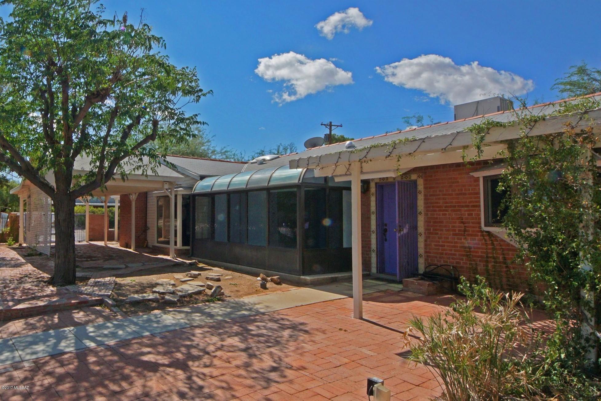 Red Brick Family Home home with pool in peaceful and convenient neighborhood. Lots of room to spread out, over 2000 sq ft.! Kitchen with granite counter tops, tiled floors, all appliances convey. Large family room and dining room. Solarium Room looks to front courtyard. Solar tubes and skylights bring in the natural light.  Central AC & heat system appear to have been upgraded within past 5 years and 80% of the windows have been upgraded to dual-pane.  Lovely, private backyard with beautiful pool and lush landscaping.  Quiet neighborhood, quick stroll to Park Mall, shops, restaurants and movie theaters! Sold in AS-IS condition.