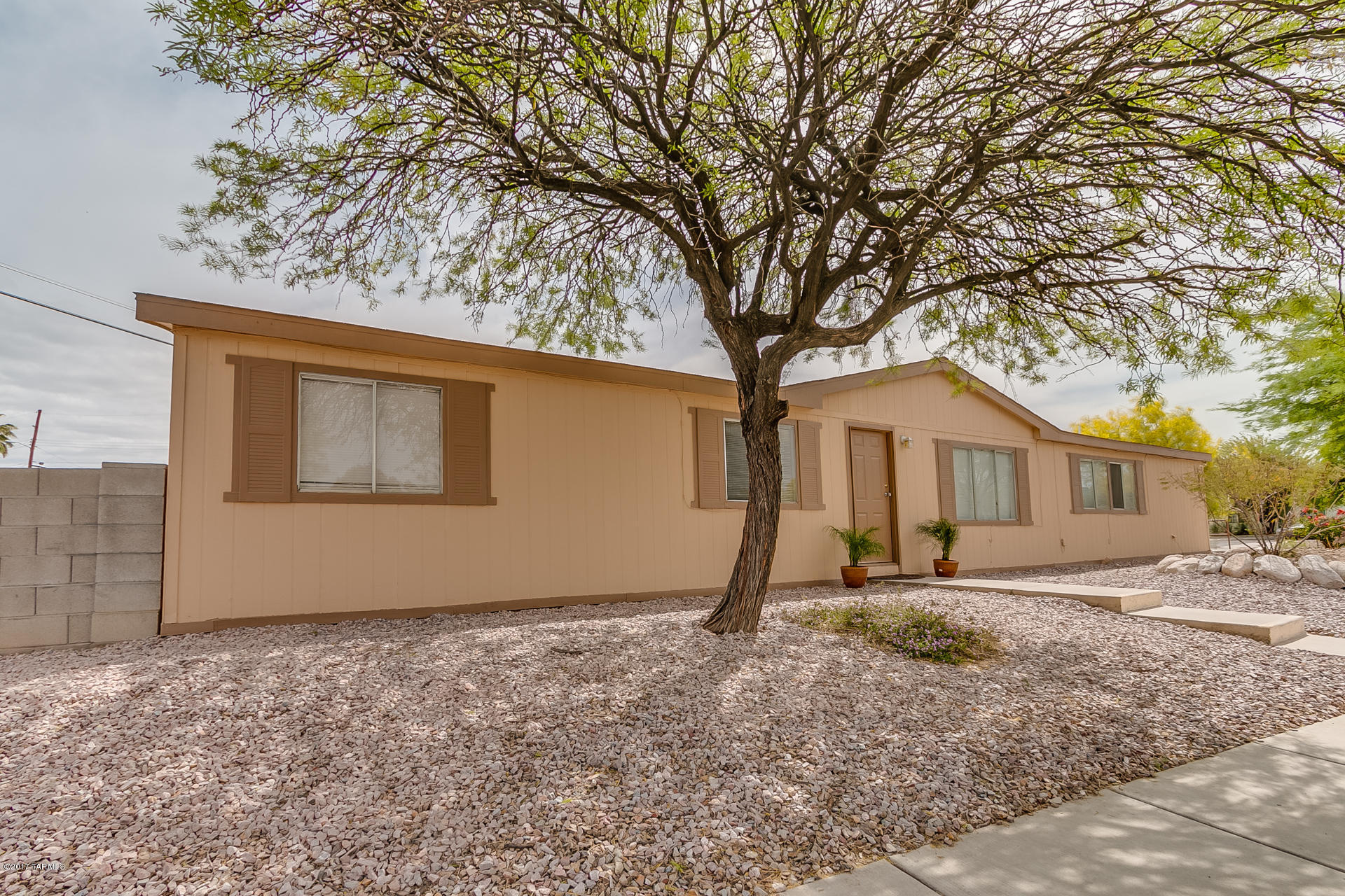 This adorable manufactured home's back yard is nestled up to the desert with no property built behind it. Newer cherry wood floors, paint, and fresh carpets this home is move in ready. Right around the corner from schools and shopping. All rooms have walk in closets that are cozy and spacious. Priced to sell, this one won't last long!