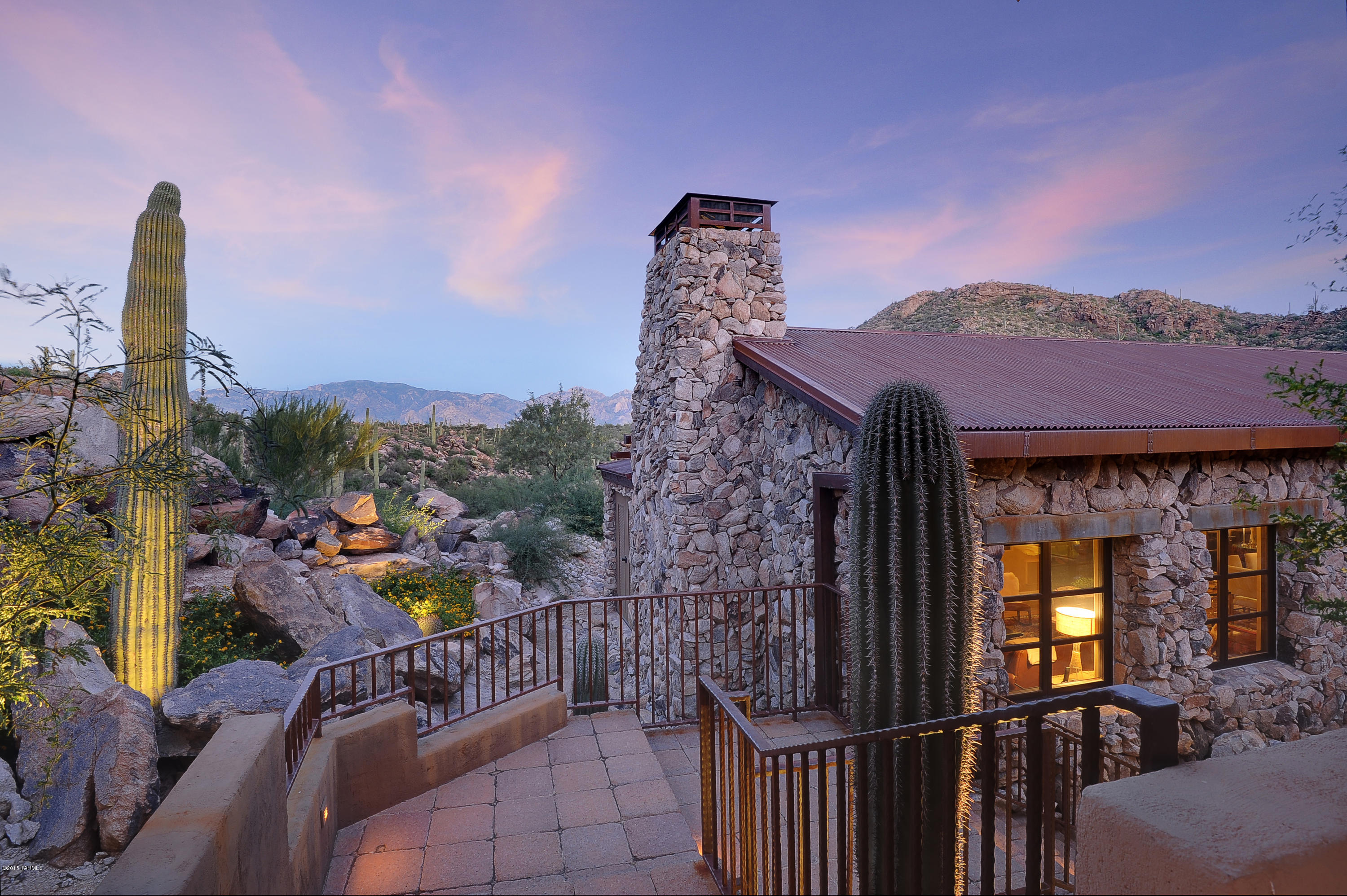 Fully furnished Move in Ready! Truly an exceptional one of a kind home in resort like setting on over 8 acres of lush desert vegetation in Saguaro Ranch. Several buildings offering a unique floor plan including guest suites with sitting rooms, guest house, media room, expansive master suite with his and hers bathrooms & closets plus study and small kitchen. Other features include gourmet kitchen, pool & spa, entertaining patios, elevator, wine room and 4 car garage. Exceptionally appointed with wood and natural stone finishes with setting a calibration of 
architecture and nature offering the finest in private desert living.