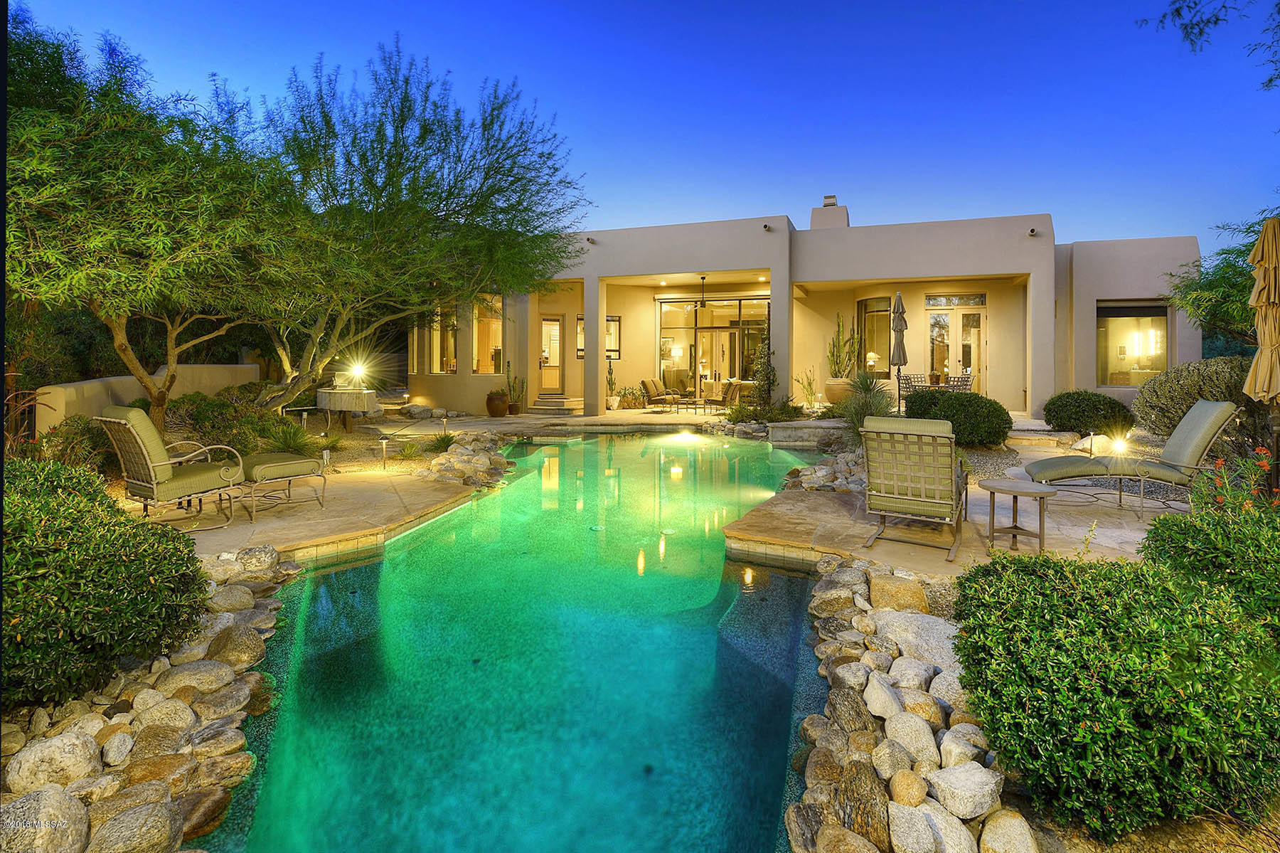 Remodeled Custom Home in Ventana Canyon. Impeccably Maintained 4BR/3BA w/Open & Bright Split Floor Plan. Living/Great Room Features Oversized Windows w/Mtn & Pool Views,Stacked Stone Fp,Floating Ceiling & Hearth,& Remote Controlled Cherry Wood Cabinet w/Hidden TV. Kitchen Opens to the Living/Great Room & Features Dark Brown Quartz Counters,Stainless Appliances,Gas Range,Breakfast Bar,Desk,Walk in Pantry,& Glass Dining Rotunda. Formal Dining Room Also Opens to The Living/Great Room.Spacious Master Suite w/Patio & Pool Access,Spa Like Bath w/Quartz Counters,Frosted Glass Shower,Free Standing Tub,and Large Walk In Closet.Other Fine Features Include Dark Brown Porcelain Floors,Newer HVAC's,3 Car Garage, & Ultra Private Outdoor Space w/Built In BBQ,Lush Landscaping, & John Stropko Designed Pool