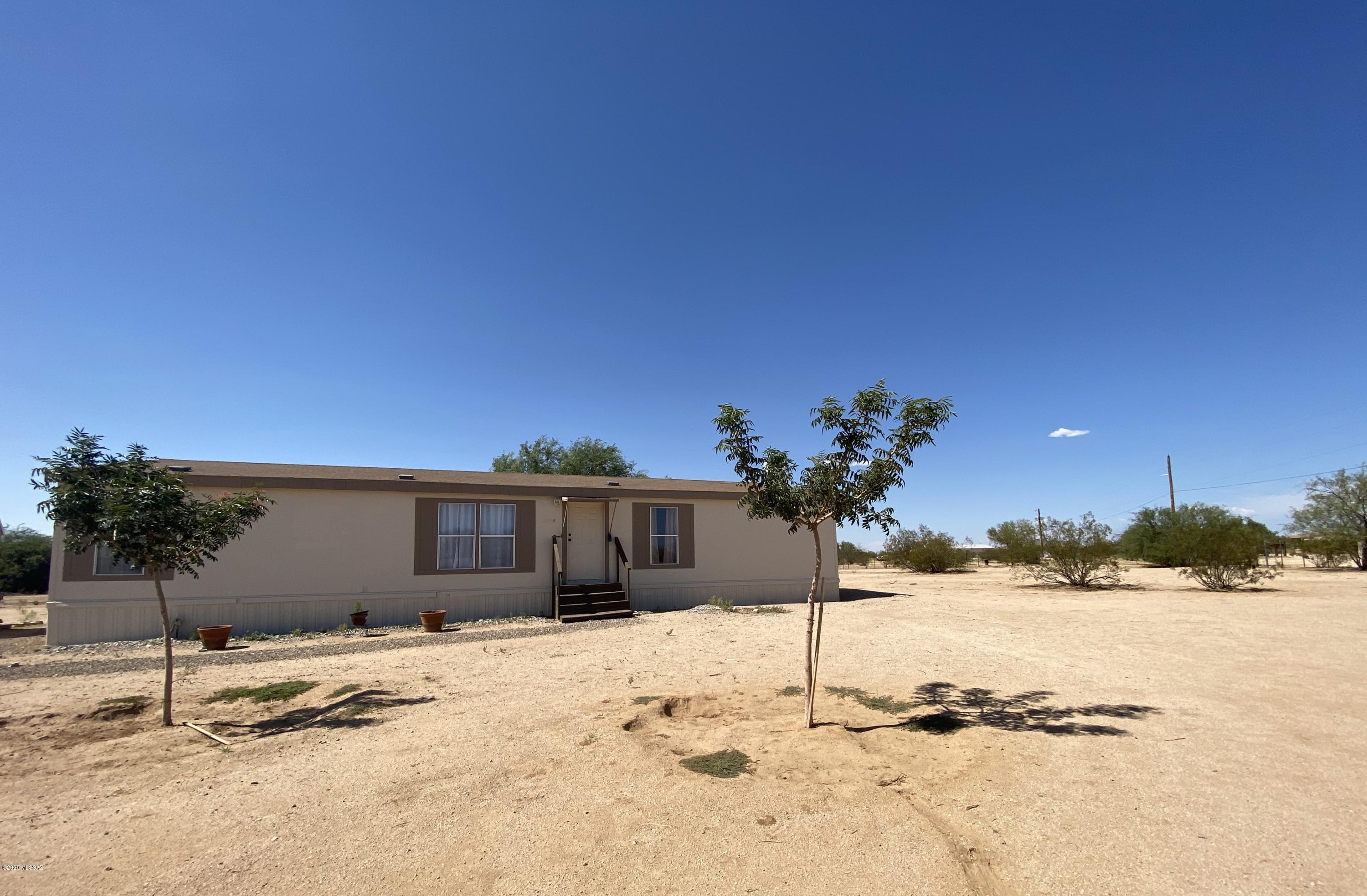 Scenic, Tranquil well maintained fully fenced horse property of nearly 2 acres, surrounded by views of the Tortolita Mountains. 3 Bedrooms, and 2 Baths. Split bedroom Floorplan. Master bedroom with soaking tub, separate walk in shower, and Double vanity sinks. Spacious kitchen, and 2 Living areas. New paint inside and out. New flooring, NO CARPET, NO HOA. RV hook ups, and Large work shed. Numerous trees throughout the property. A few minutes to I-10. Ideal for horse riding, Biking, and Hiking. Country Living at its best.