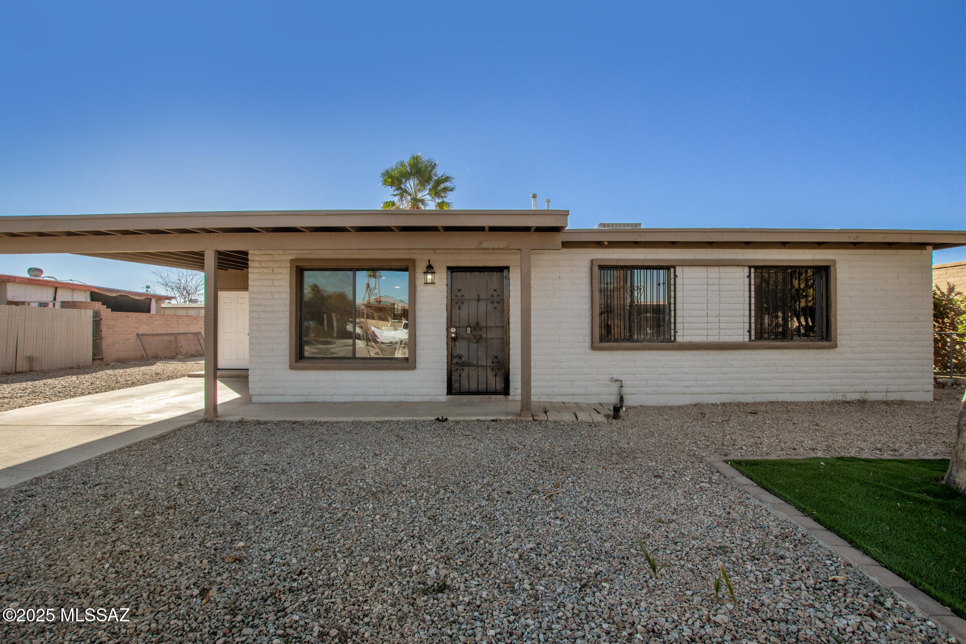This well-maintained 3-BR, 1-BA home offers a light and bright living space with an inviting open layout. The upgraded kitchen features crisp white cabinetry, recessed lighting, and stainless steel appliances. Both bedrooms are generously sized, providing comfortable retreats. The interior is finished with a warm color palette and durable tile flooring throughout. Additionally, there is a bonus room with built-in storage that could easily be used as an office, workout room, or even an extra bedroom to suit your needs. Step outside to the spacious backyard, where you'll find existing palm trees and a large lot with great potential to create your ideal outdoor oasis, and a private RV gate. This home is an excellent opportunity you won't want to miss!