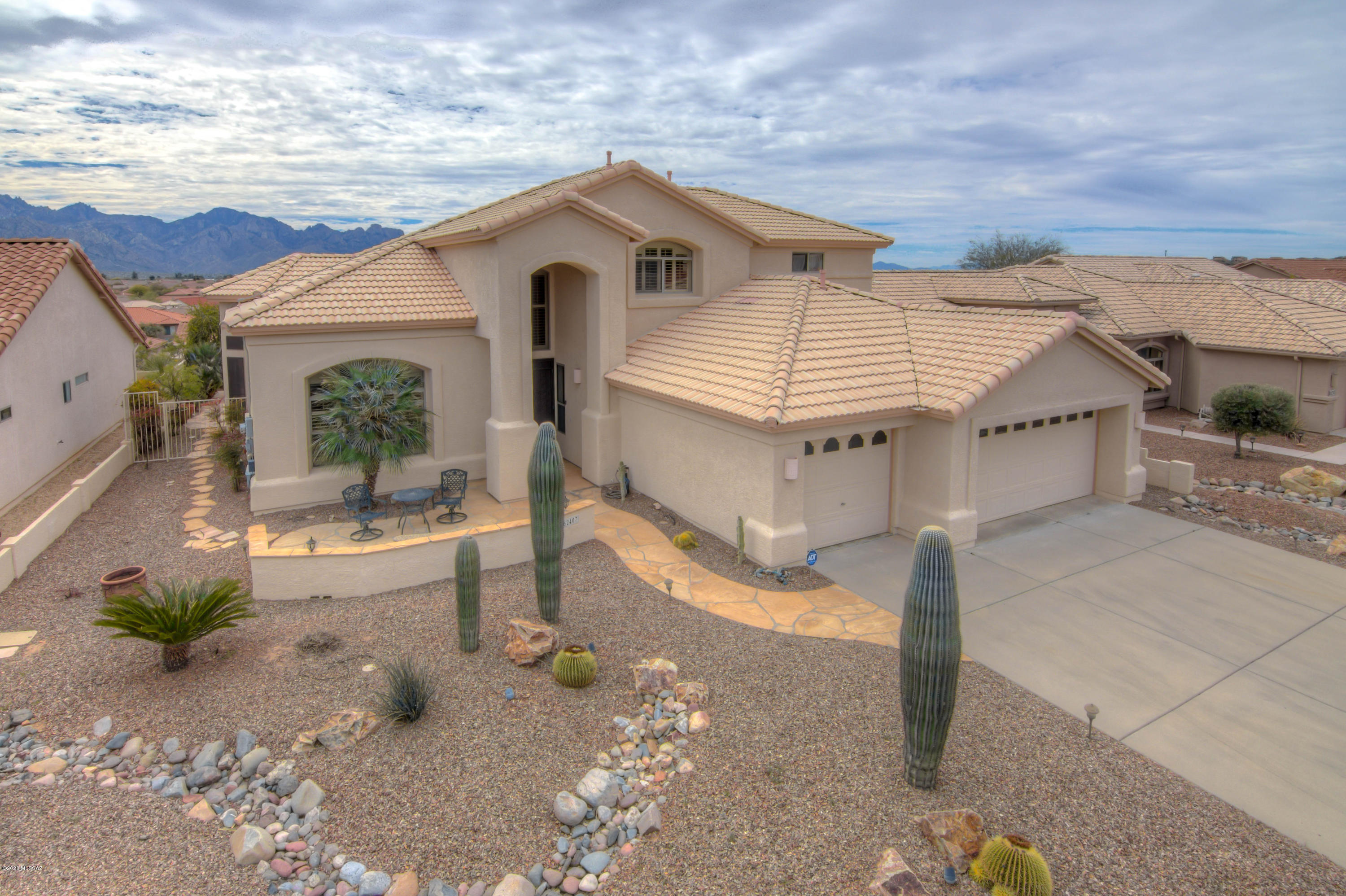Come take a look at this elegant Sundance located in the desirable Saddlebrooke Community. Inside this home find a sweeping staircase, living room with soaring ceilings a stunning dining room with tray ceilings. The chef's kitchen looks out to amazing panoramic views of the mountains. The backyard feels like you are on top of the world. The patio has a built in BBQ and you will love the pool and spa along with a soothing waterfall. The master suite is on the main floor with it's own mountain views and has 2 huge walk in closets, a jetted tub in the bathroom, dual vanities and a BIDET! You will have plenty of room for family and friends to visit with 2 bedrooms upstairs plus a Jack and Jill bathroom. Owned solar system. The 3 car garage is extended with built in storage. Don't miss out!