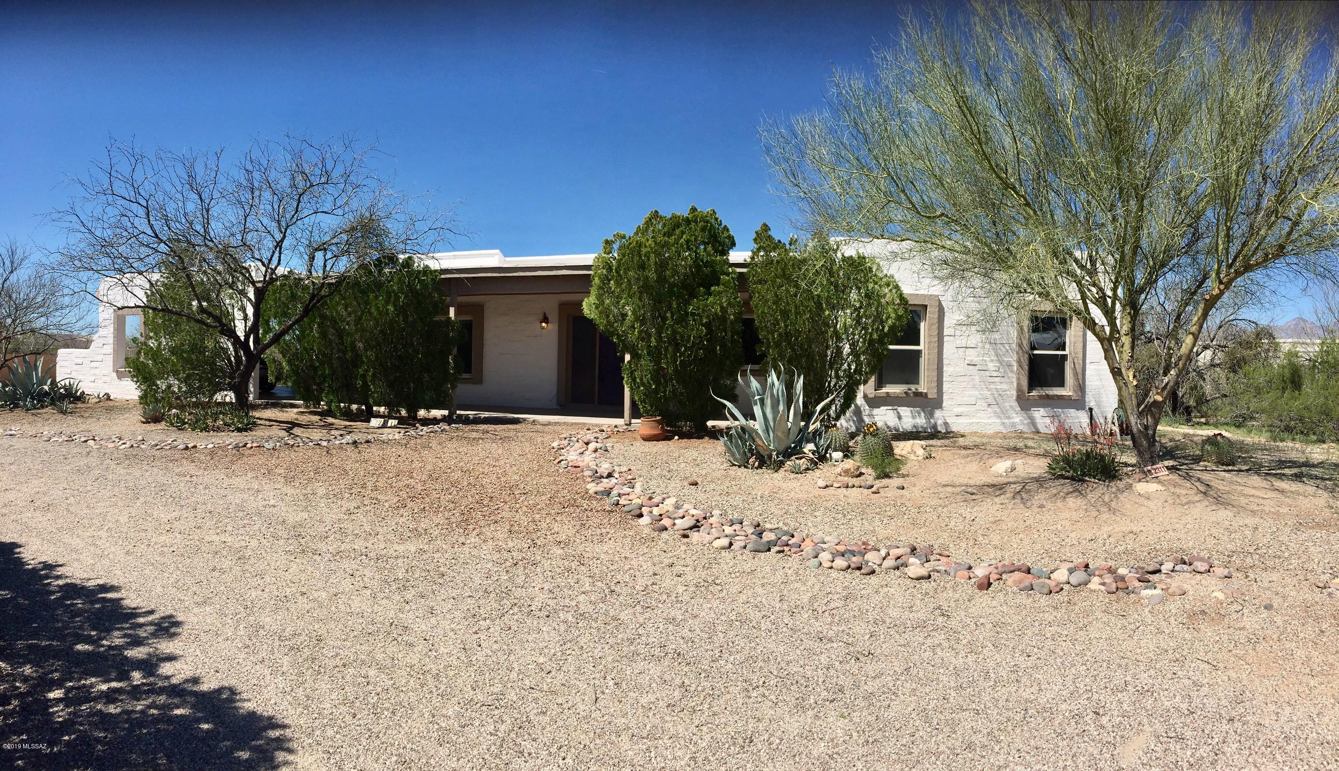 Charming slump-block home , bordering natural desert, with stunning views of the mountains.  Located short distance from Aqua  Caliente Park.  Skylights, vaulted ceilings, and an open floor plan makes this property bright , spacious, and great for entertaining.  Brick fireplace, pool and spa, are only some of the many features this property has to offer. Walled-in back yard 
 provides many different possabilities for gardens, dog run, or terraces. Cement pad for motor home is on the north side of the property.  Plenty of room to build a guest house or artists studio. This property is a must-see to appreciate it!  Seller is motivated!