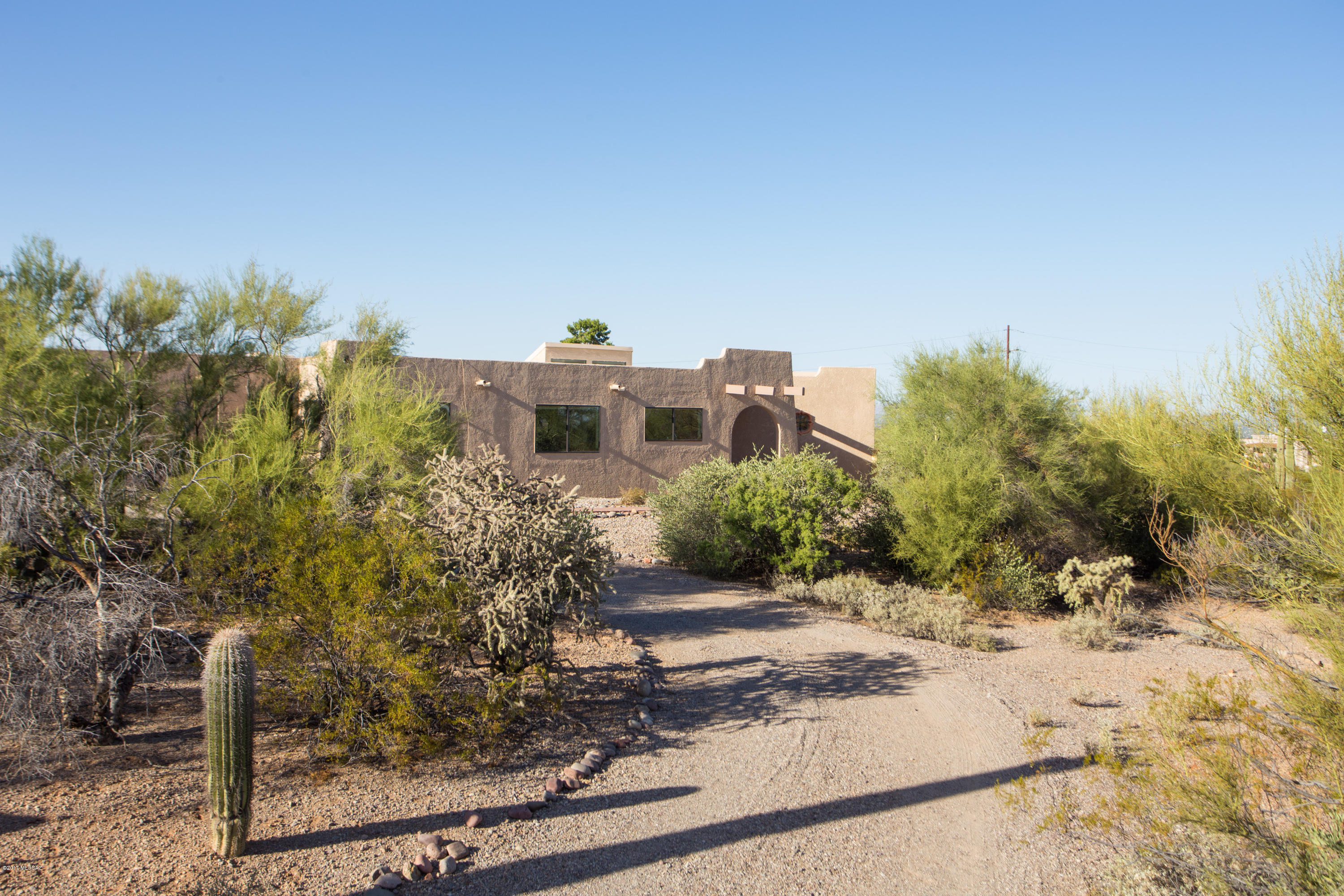 .Beautifully Updated Custom Territorial on Lush 3.46 Acre Lot with Gorgeous Views in Every Direction! You’ll Appreciate the Many Updates which Include the New Maple Kitchen with Stainless Appliances and Travertine Floor and Countertops, 3 Updated Baths, All New Plumbing Fixtures, Light Fixtures, Ceiling Fans, Doors and Fresh Paint! You’ll Love the Bright Flowing Split Bedroom Floor Plan with Large Romantic Master Suite with One Of Two Rustic Rhyolite Stone Fireplaces and Separate Tub and Shower! Check Out the Super Sized 2.5 Car Garage! The Backyard is a Blank Slate Awaiting Your Creative Touch! Relax or Entertain on the Huge Front Patio with Glorious Catalina Mountain Views and Overlooking the Twinkling Lights of the Tucson Valley!  Easy Access to Downtown and I10!