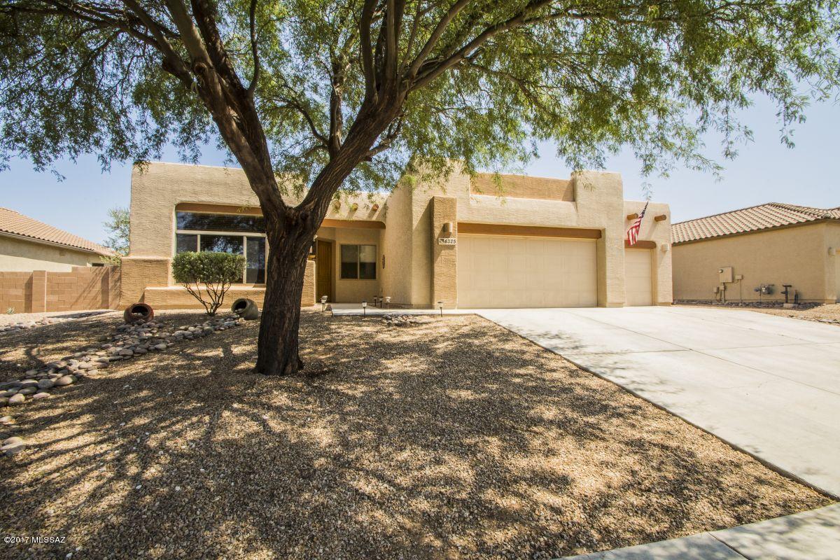Move-in ready home with breathtaking mountain views in a quiet neighborhood. This wonderful home is close to shopping, parks, Casino Del Sol, Ryan Air Field and so much more. Three bedrooms and a den/office, formal living and dining area, family room has a bee-hive fireplace with a heatilator which warms the home so you don't need to turn on your furnace during our short winter months. Fabulous back yard with fruit trees and lots of room to install a pool later on and the views are wonderful from the covered patio. The 3-car garage has a 220 outlet and several 110 outlets, professional grade street shelves and 3-wooden cabinets. The roof was recently coated by a professional roofing company so no need to worry about roof issues. Carpets throughout home were just shampooed. Sellers are leaving all the appliances so all you need to bring are your personal belongings and this will be your home. Sellers are offering a 1-year home warranty that will cover all the appliances. The TV, TV mount and the surround sound speakers in the family room will not convey. This is a wonderful home in a great area and it's priced to sell. Come and tour the home an you'll fall in love and want to make it your own.