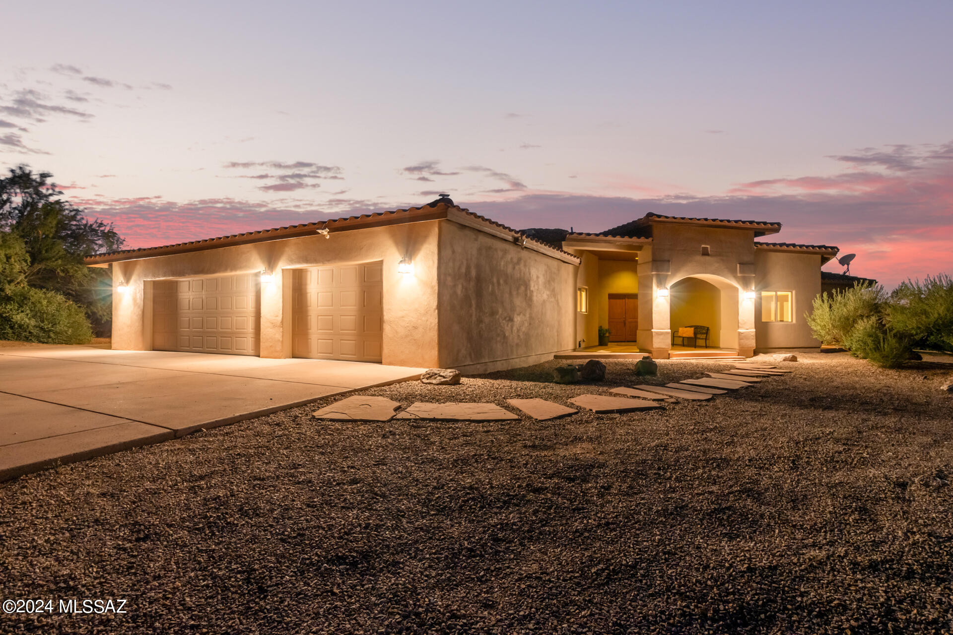 Welcome to this stunning signature home on 3.45 acres on the west side of Tucson, near the Tucson Mountains! The grand entryway leads to a separate formal dining room and a living room with a cozy fireplace. The custom kitchen boasts granite countertops, solid wood cabinets, stainless steel appliances, a bar with seating, a pantry, and a built-in desk area, all seamlessly connected to a spacious family room. The amazing split floor plan includes a luxurious main bedroom and bath featuring travertine countertops, a stone floor, a separate tub, and a shower. You'll find solid wood doors, 12-foot ceilings, and freshly painted interiors and exteriors throughout the home. The covered patio spans the length of the home, with a spectacular view overlooking the Tucson Mountains, a pool, and a spa, perfect for relaxation or entertaining. Additional features include a large laundry room, a three-car garage with built-in storage, ample parking, and a paved road leading to the property. This home offers the perfect blend of luxury and comfort. Experience the best entertainment and personal retreat in this exceptional property!
