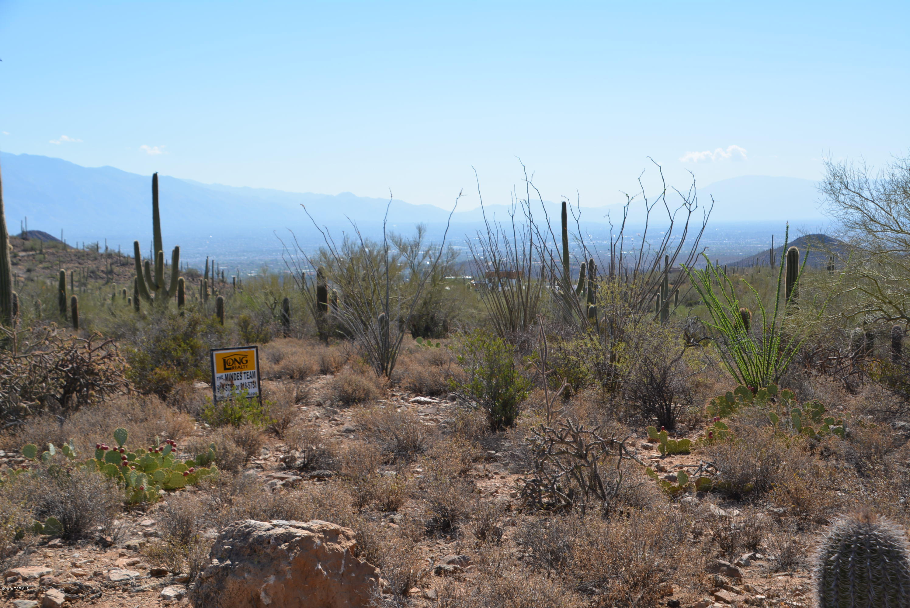 Here you are on top of the world. Adjacent to Pima County land which is next to Saguaro National Park. Untouched and pristine saguaro studded homesite above the city with dazzling views, easy terrain, close to shopping and I-10 in an area of fine custom homes. Great price for  great parcel, horses allowed. Sign is at SW corner.
