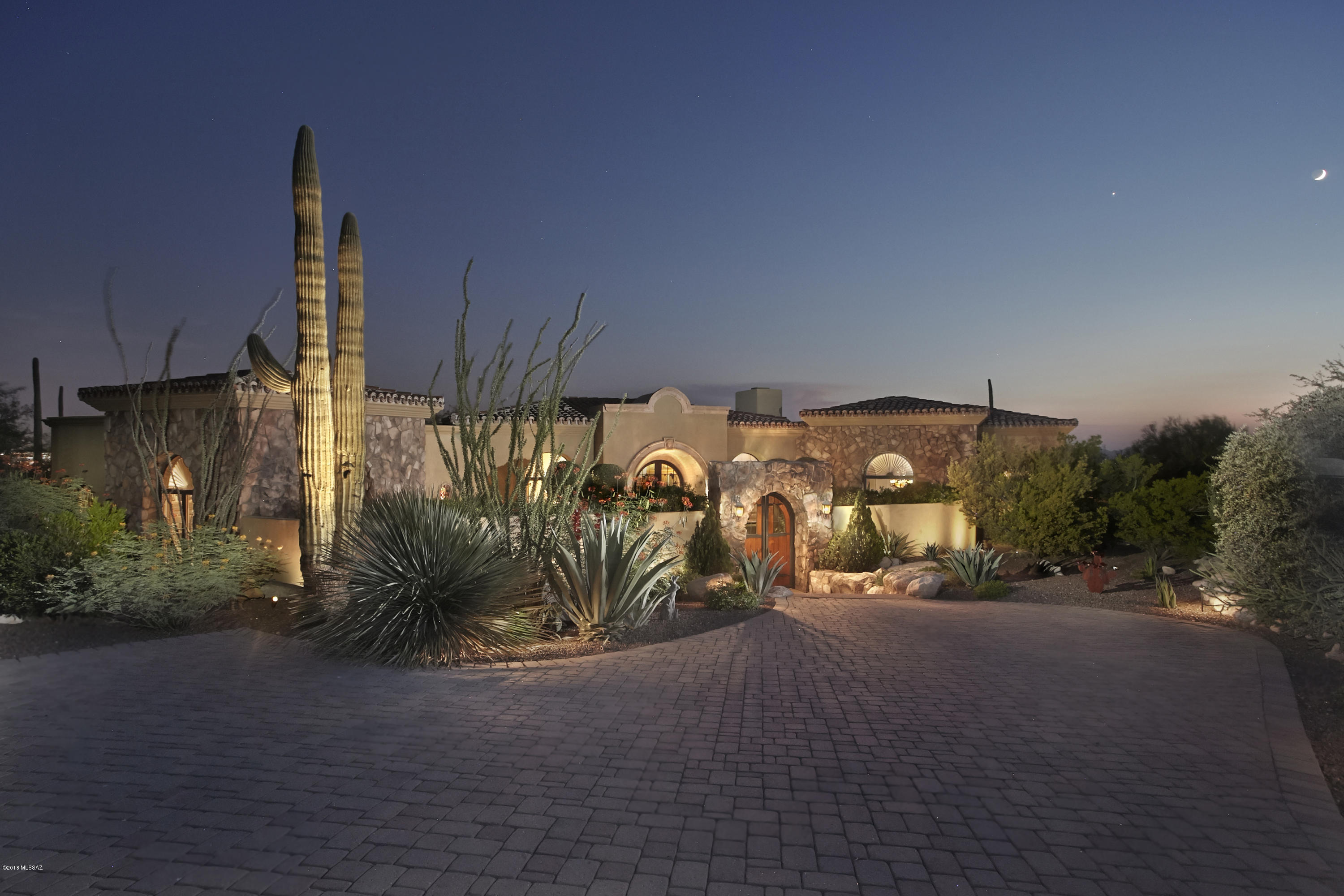 Transport yourself to Italy by this exquisite Tuscan Villa in Tucson's prestigious Pima Canyon.  From the gated  courtyard to the 1000 sq.ft. great room w/ floor to ceiling hand carved cantera fireplace & soaring beamed ceilings, hand painted murals and stained glass, no detail was overlooked in creating this gracious masterpiece. Built by Doug Mills, this home must be seen to fully appreciate the quality and artful design. The 1.2 acre corner lot offers privacy and outstanding  mountain views.  The floor plan boasts a gracious master wing w/cantera fireplace and nearby library w/custom bookcases. The guest rooms have ensuite baths & a private courtyard with a cantera fountain.  The gourmet kitchen w/slab granite center island, walk-in pantry would delight the most discerning chef. The huge game room w/fully equipped bar and exercise room or 4th BR is the perfect place to relax or entertain.  The spacious back yard w/outdoor kitchen and fountain has plenty of room for a pool. This home has it all!