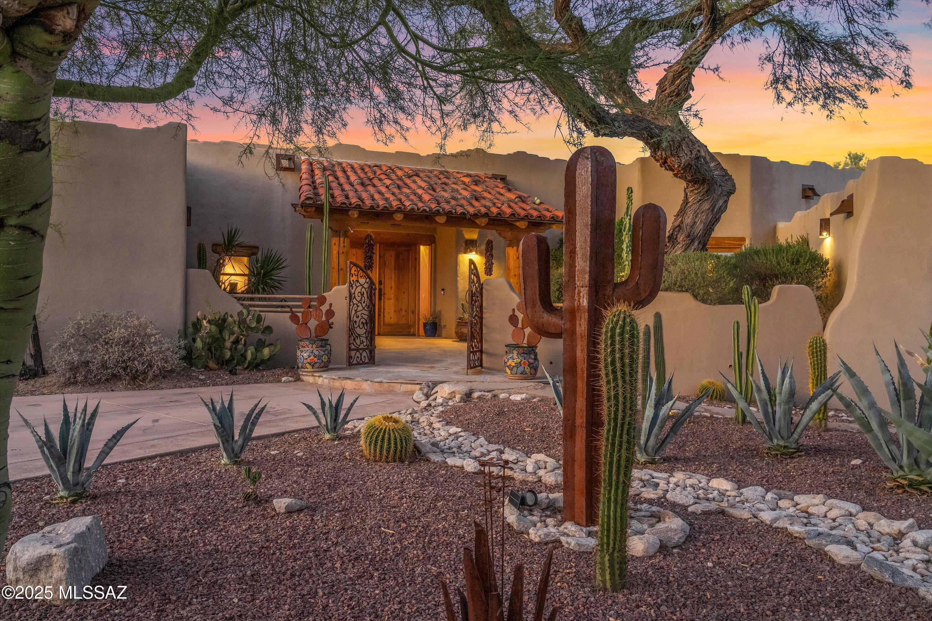 Luxury living in La Paloma. This stunning residence captures Tucson's beauty with mountain sunrises and Catalina Foothills lights at night. Inside, hand laid saltillo tile, soaring ceilings, and natural light create timeless elegance, while the chef's kitchen with GE Café double ovens, farmhouse sink, and raw edge granite is built for gatherings. The owner's suite offers a spa style bath with copper soaking tub, artisan tile shower with jets, and private exercise room. A private casita with two bedrooms, full kitchen, kiva fireplace, and verandas provides comfort and independence. Outdoors, enjoy a resurfaced pool, copper accents, and expansive patios. Minutes from La Paloma Country Club and upscale shopping and premier restaurants of La Encantada, making every day feel like a retreat.