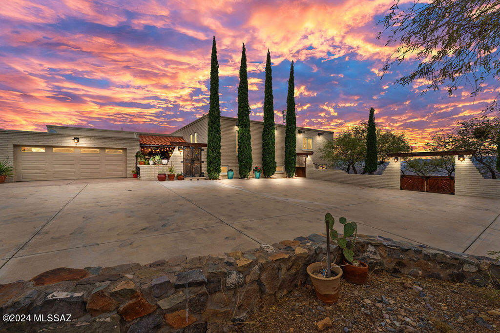 Experience the ultimate in tranquility and natural beauty! Nestled on just over 3 acres, this 4-bdrm, 3-bath home offers unparalleled panoramic views of majestic mountains, breathtaking sunsets, and invigorating sunrises. The expansive decks that wrap around two-thirds of the home provide the perfect vantage point to soak in the natural beauty that surrounds you.

Step inside, and you'll be enveloped in an open and airy ambiance, filled with an abundance of natural light streaming through all-new Anderson Renewal windows and sliders. The seamless integration of the indoors and outdoors enhances the spacious living areas, allowing the breathtaking scenery to become an integral part of your daily life. As you traverse the home, the warmth of stained textured concrete and porcelain floors beneath your feet complements the exposed wooden beams overhead, creating a harmonious blend of comfort and rustic elegance. The open floor plan seamlessly connects the living spaces, making it a perfect setting for entertaining friends and family.

Immerse yourself in the serenity of your private hot tub, strategically placed on the expansive decks to capture the best views the property has to offer. Whether you're unwinding after a long day or stargazing under the clear mountain skies, this outdoor oasis is a true retreat.

The large primary suite is a haven of comfort, featuring a generously sized bedroom with its own private balcony and a luxurious ensuite bathroom. The additional bedrooms are equally spacious, offering comfort and privacy for family and guests. Ample storage space ensures that your belongings are neatly organized, making daily life a breeze.

With its perfect blend of natural beauty, thoughtful design, and spacious interiors flooded with light, this home is not just a residence; it's a sanctuary. Discover the ultimate living experience and make this retreat your own. Seize this opportunity to enjoy a lifestyle of tranquility and luxury in a home that captures the essence of living at its finest.