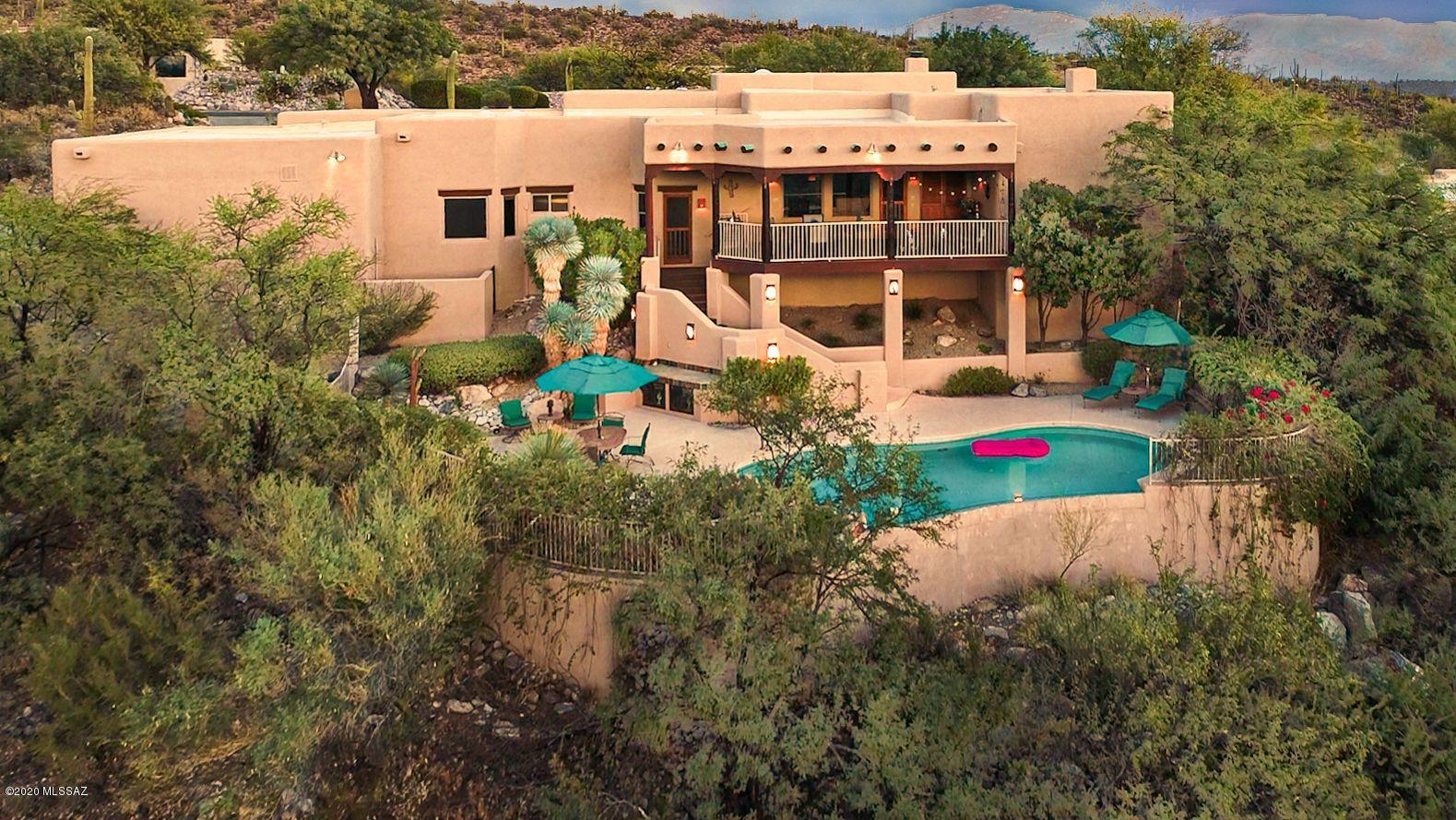 Natural & sophisticated w/extraordinary views high on a ridge in Alta Vista. This   exceptional & surprisingly private Arizona southwestern style home w/city & mountain views from every rm welcomes you into a lovely front courtyard w/fountain, exquisite living rm w/high beam ceilings, dramatic fireplace, walls of windows, formal dining rm, light & open gourmet island kitchen w/tile countertops, stainless steel appliances, gas cooktop, breakfast area, saltillo tile flrs, antique Peruvian doors open to large family rm, 3 BRs, 3.5 BA's including master suite w/fireplace, lux bath w/dble vanities, jacuzzi tub, separate shower, lg walk in closet & private entry to serene covered veranda. Enjoy resort like bkyd w/ pool, spa, lg balcony, citrus trees, mtn, city & sunset views, Dist.16 schools..