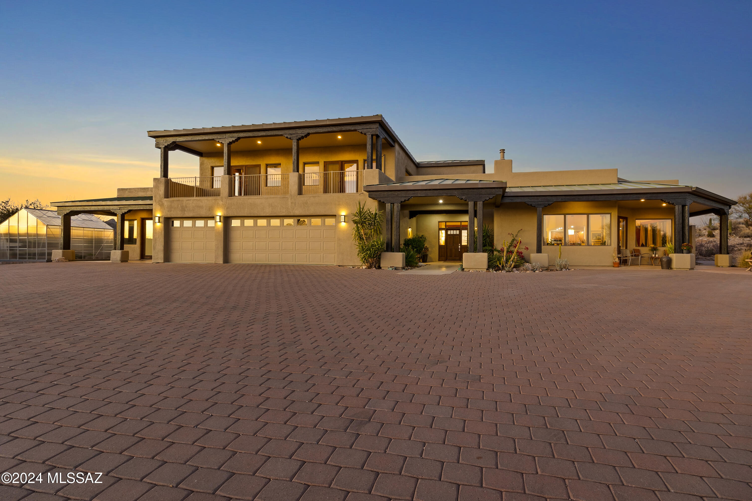 PICTURE-PERFECT VIEWS AND ELEGANT SOUTHWEST LIVING! Discover unparalleled desert serenity in this stunning custom Santa Fe home nestled on over 8 acres of pristine natural landscape in the exclusive La Cholla AirPark. This thoughtfully designed retreat harmonizes luxury and nature, featuring an open floor plan with large, strategically placed windows that frame breathtaking views and invite the outdoors inside.
The primary bedroom is conveniently located on the main floor, complete with a spa-like ensuite boasting a soaking tub, walk-in shower, and his-and-hers walk-in closets. The chef's kitchen showcases granite countertops, rich cherry cabinetry, and flows seamlessly into the living areas, perfect for entertaining. An indoor heated lap pool and hot tub offer year-round relaxation, while the elevator leads to a spacious second story with a den and an additional room featuring fabulous views of the desert and mountains. Step outside to the dream outdoor kitchen, ideal for hosting gatherings under the expansive desert skies. A separate entry to private guest quarters ensures comfort and privacy for visitors. This one-of-a-kind property allows you to fully embrace the sought-after La Cholla AirPark lifestyle, with its unique blend of luxury, privacy, and access to a vibrant aviation community.
Schedule your private tour today and experience desert living at its finest!